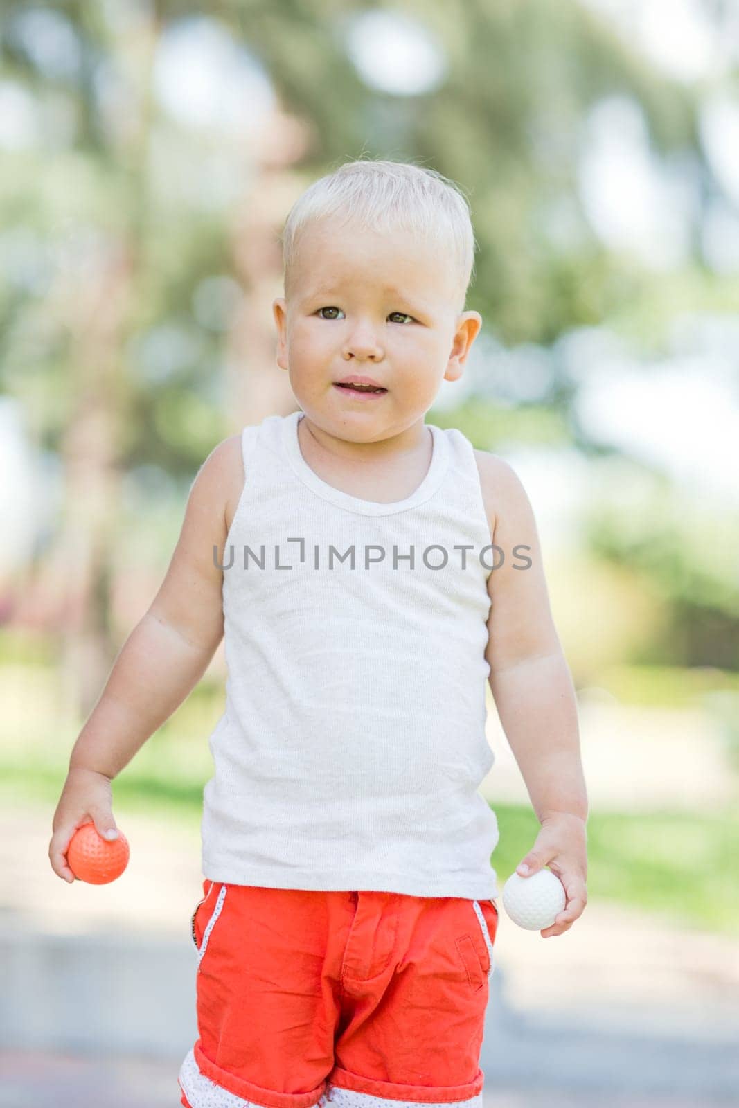 Baby boy playing toy golf outdoor