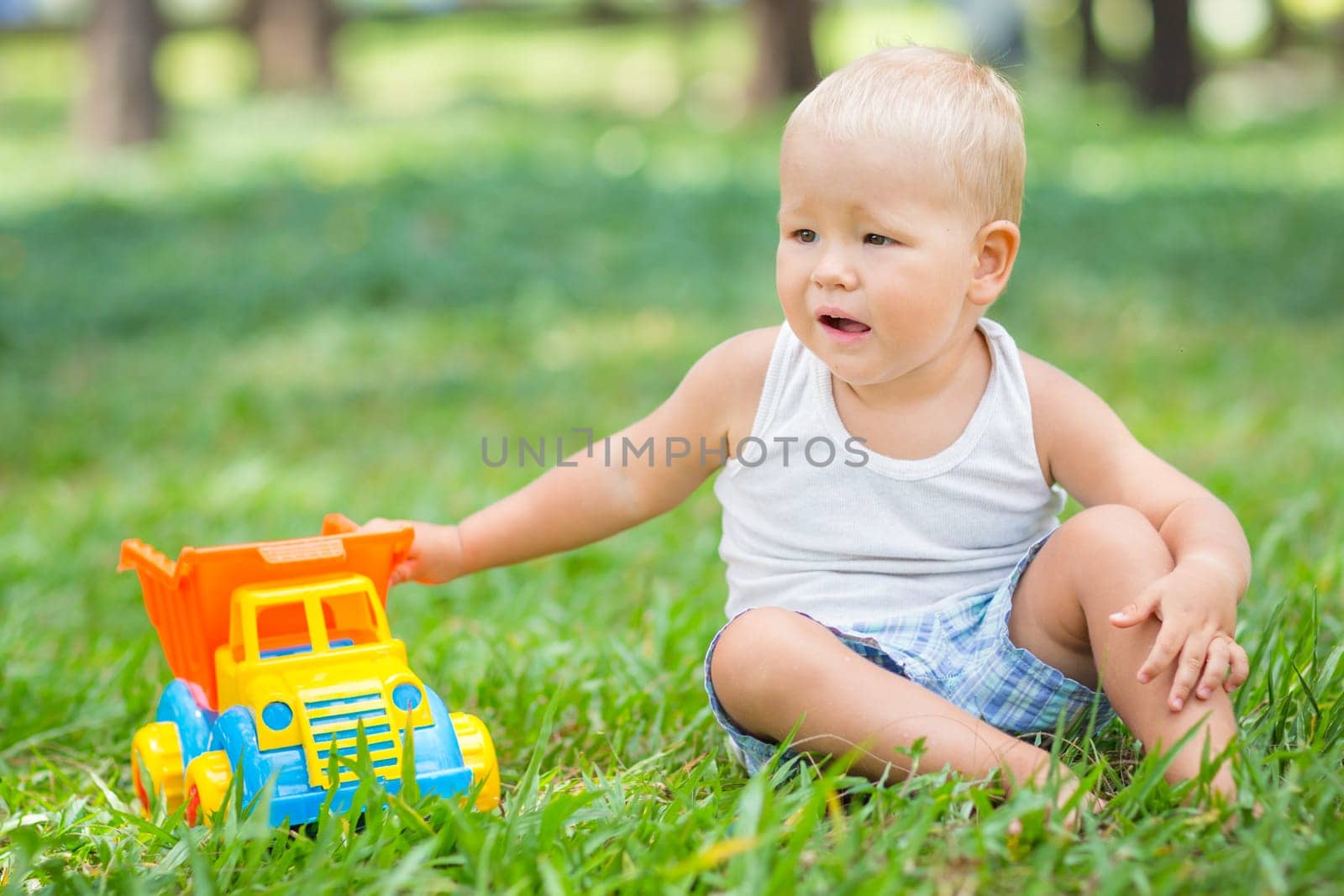 Little boy is playing toy car