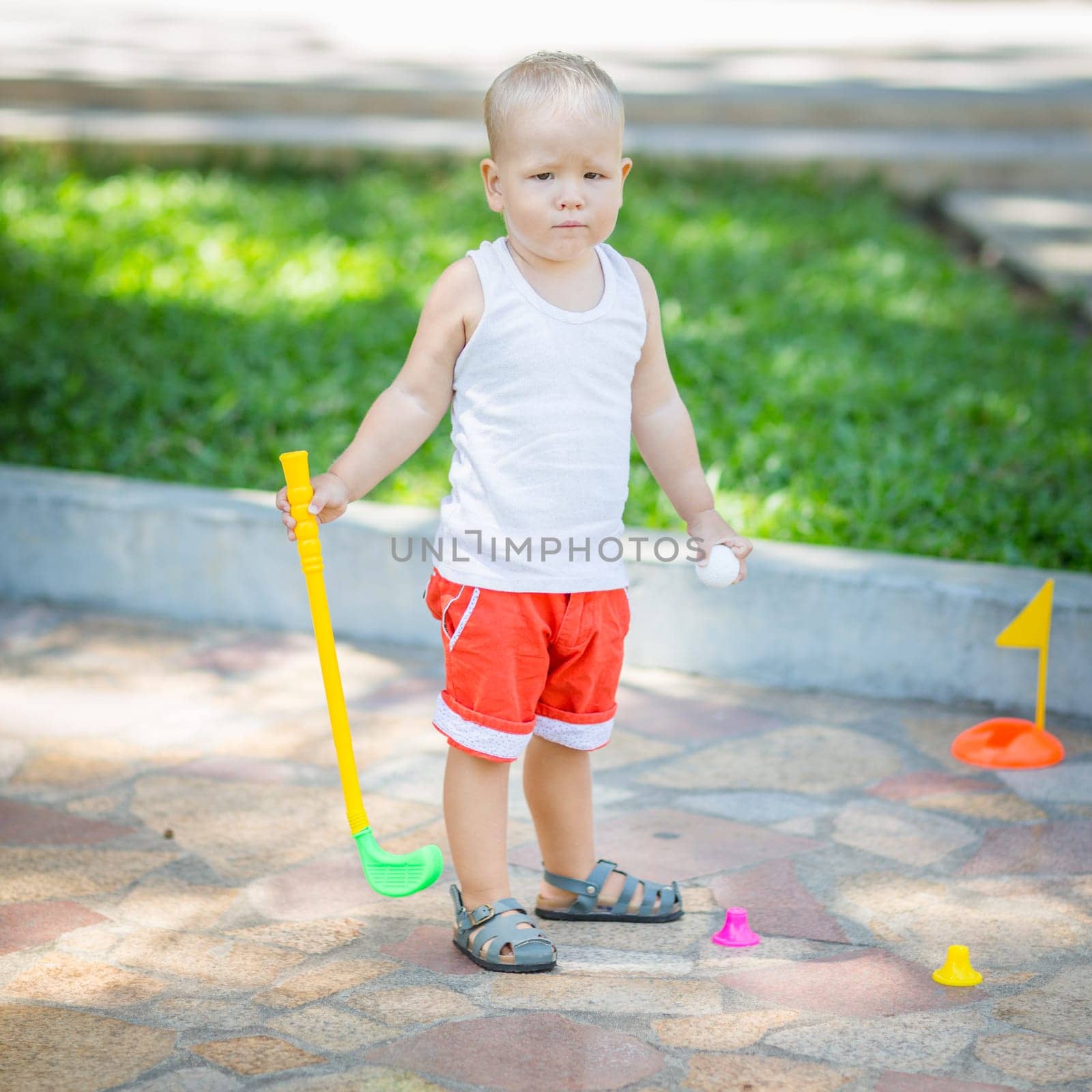 Baby boy playing toy golf outdoor