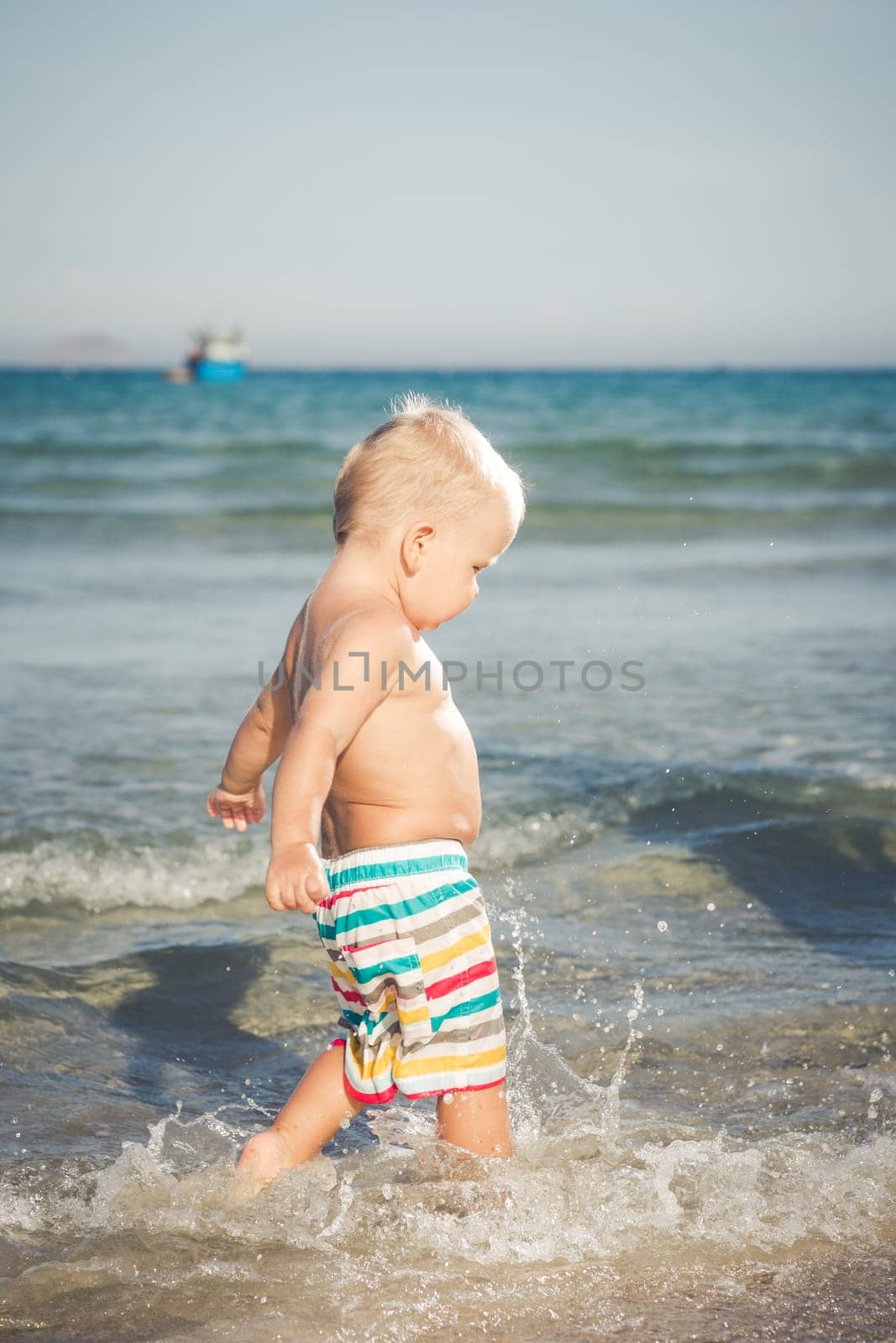 Cute baby plays in a sea