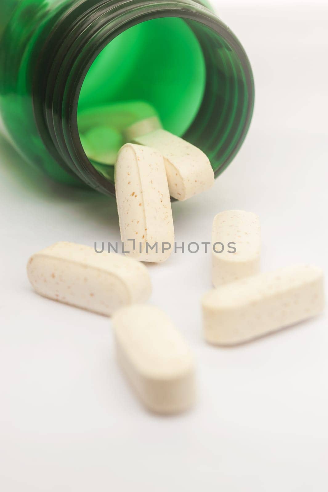 Vitamin spilling out of a bottle, Selective focus