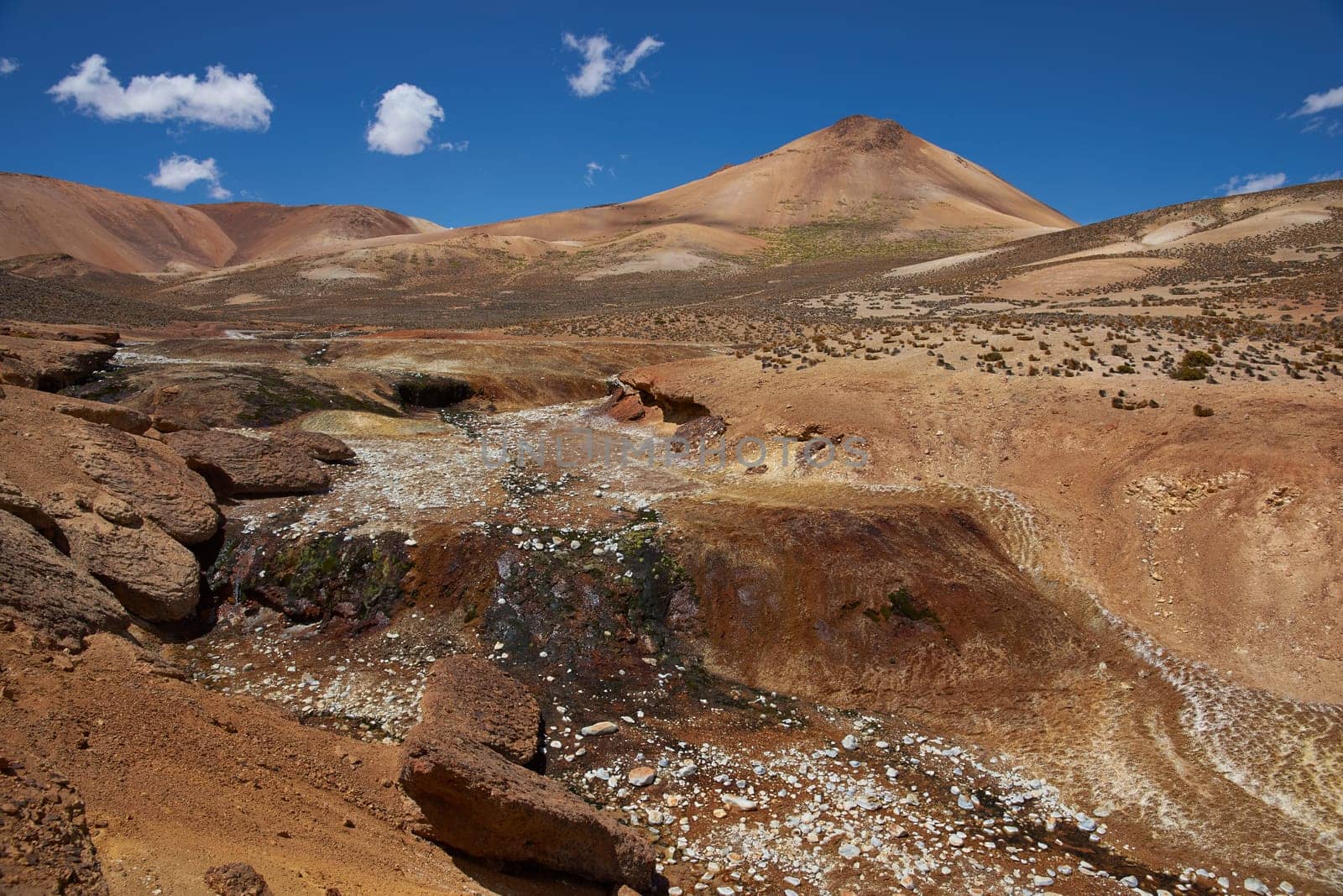 Dry riverbed running through the colourful desert landscape in Lauca National Park set in the altiplano of northern Chile