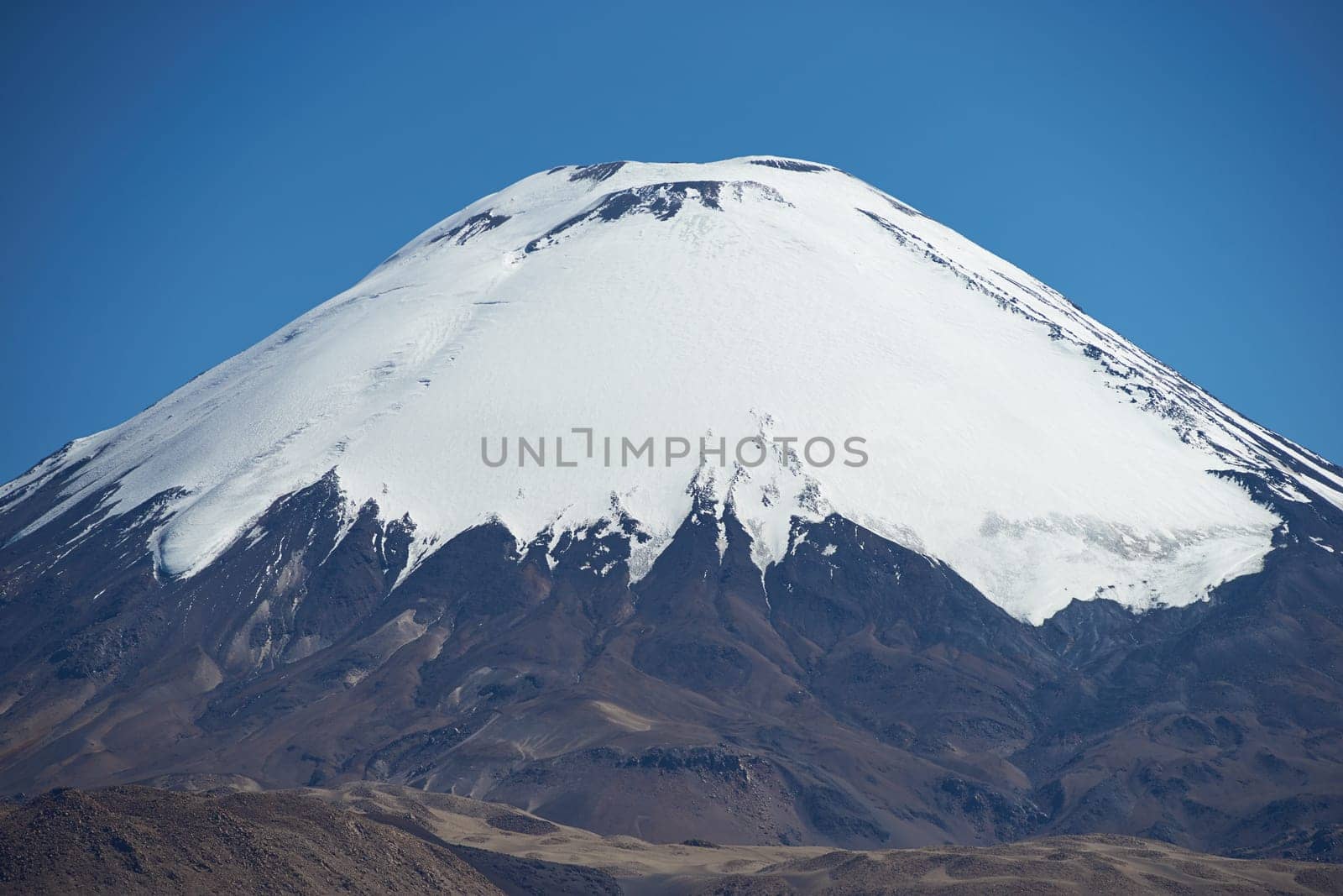 Snow capped peak of Parinacota Volcano, 6,324m high, in the Altiplano of northern Chile.