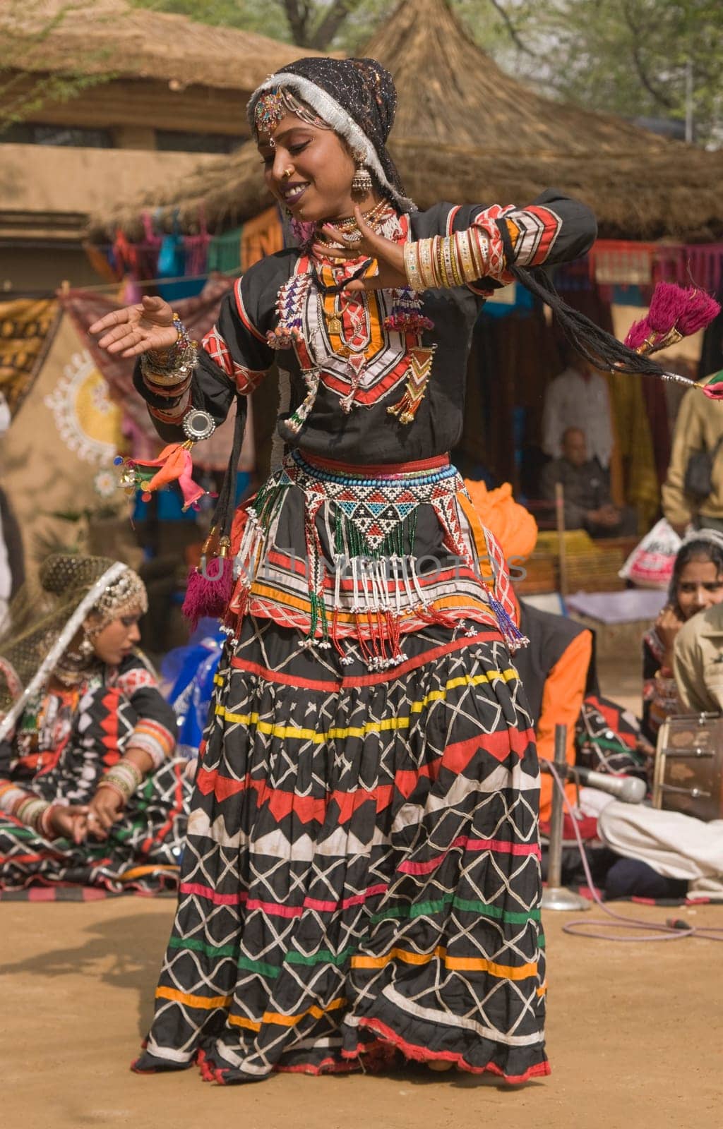Female Indian Kalbelia dancer from Rajasthan performing at the annual Sarujkund Fair near Delhi in India.