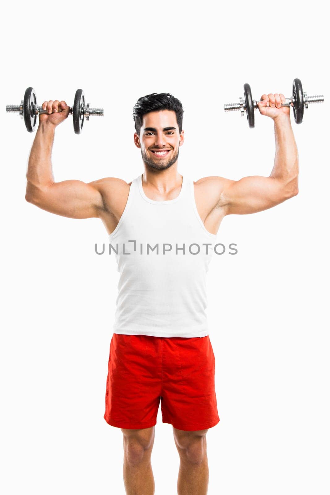 Portrait of handsome young man lifting weights, isolated on white background