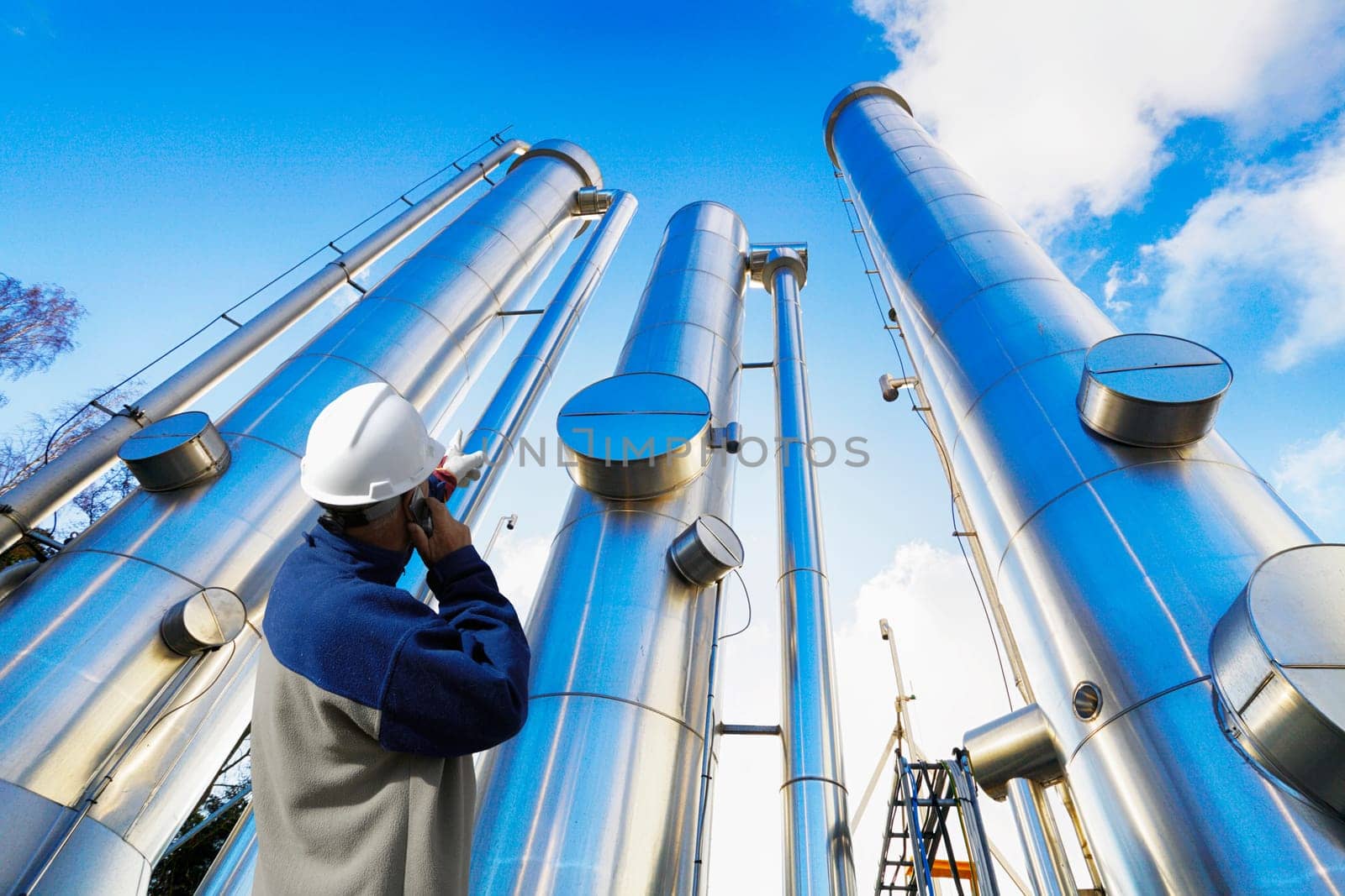 oil and gas worker with giant pipes, pipelines