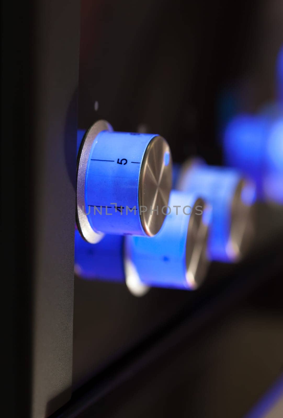 Blue rotary knobs on black panel