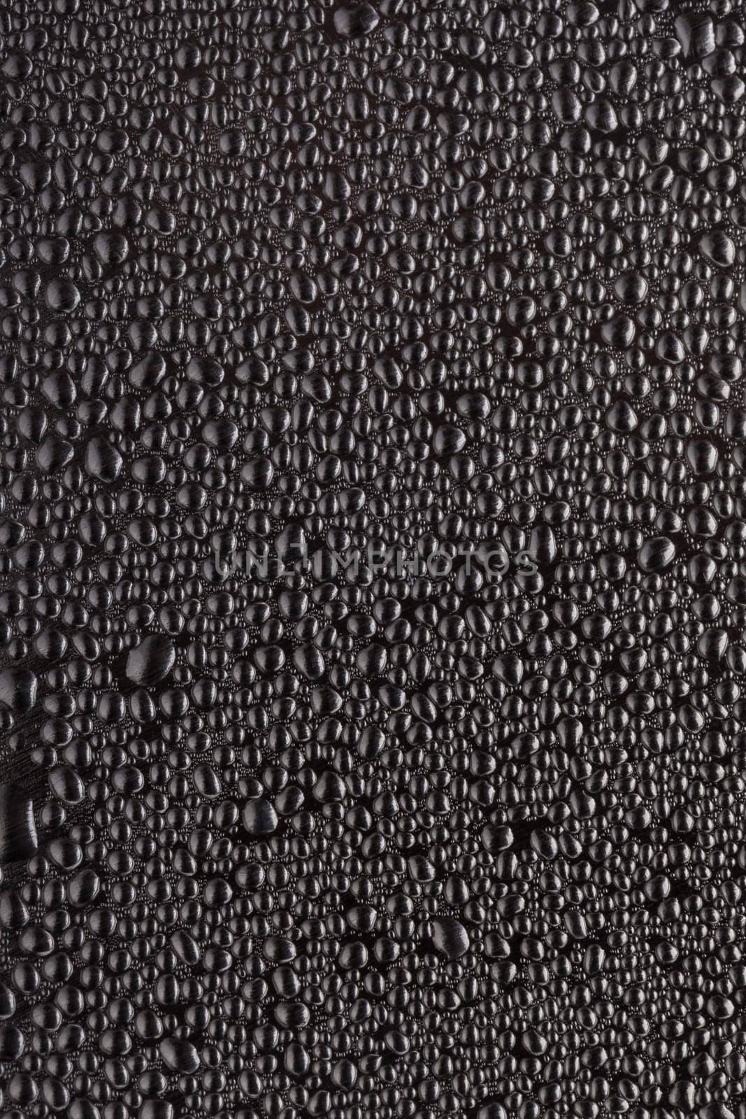 Black drops with light reflection on surface