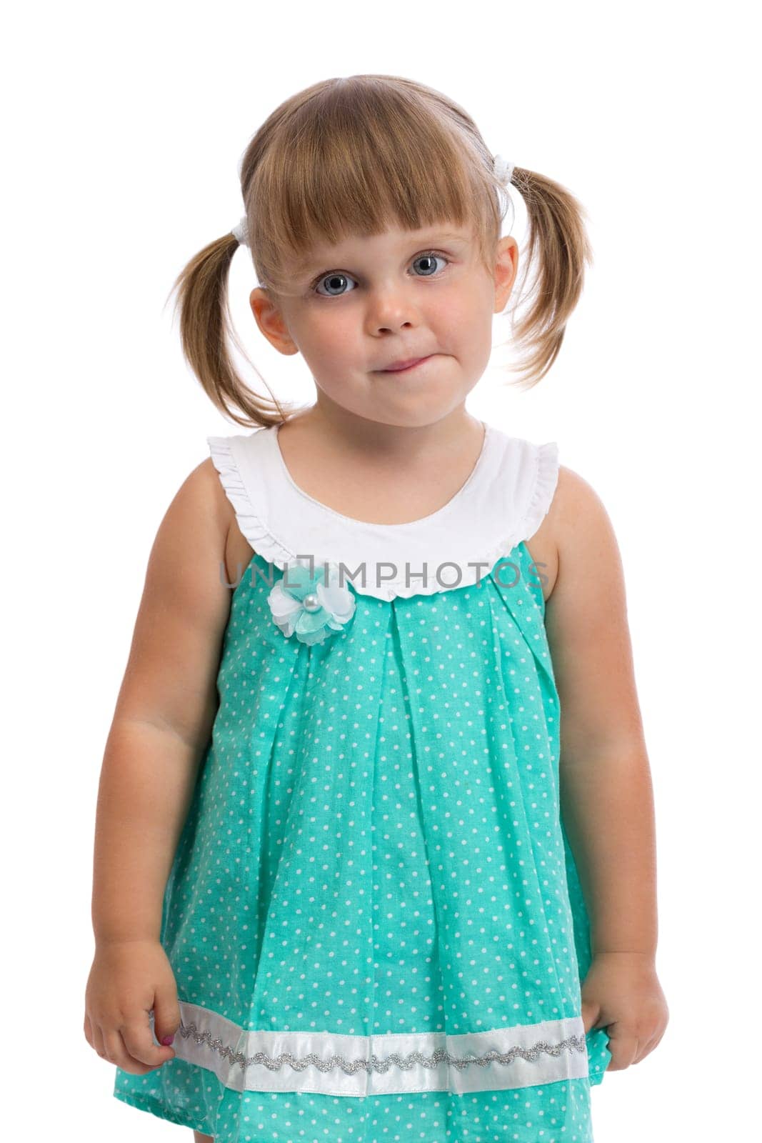 Portrait of a little three year old charming girl in the studio on a white background. Isolate.