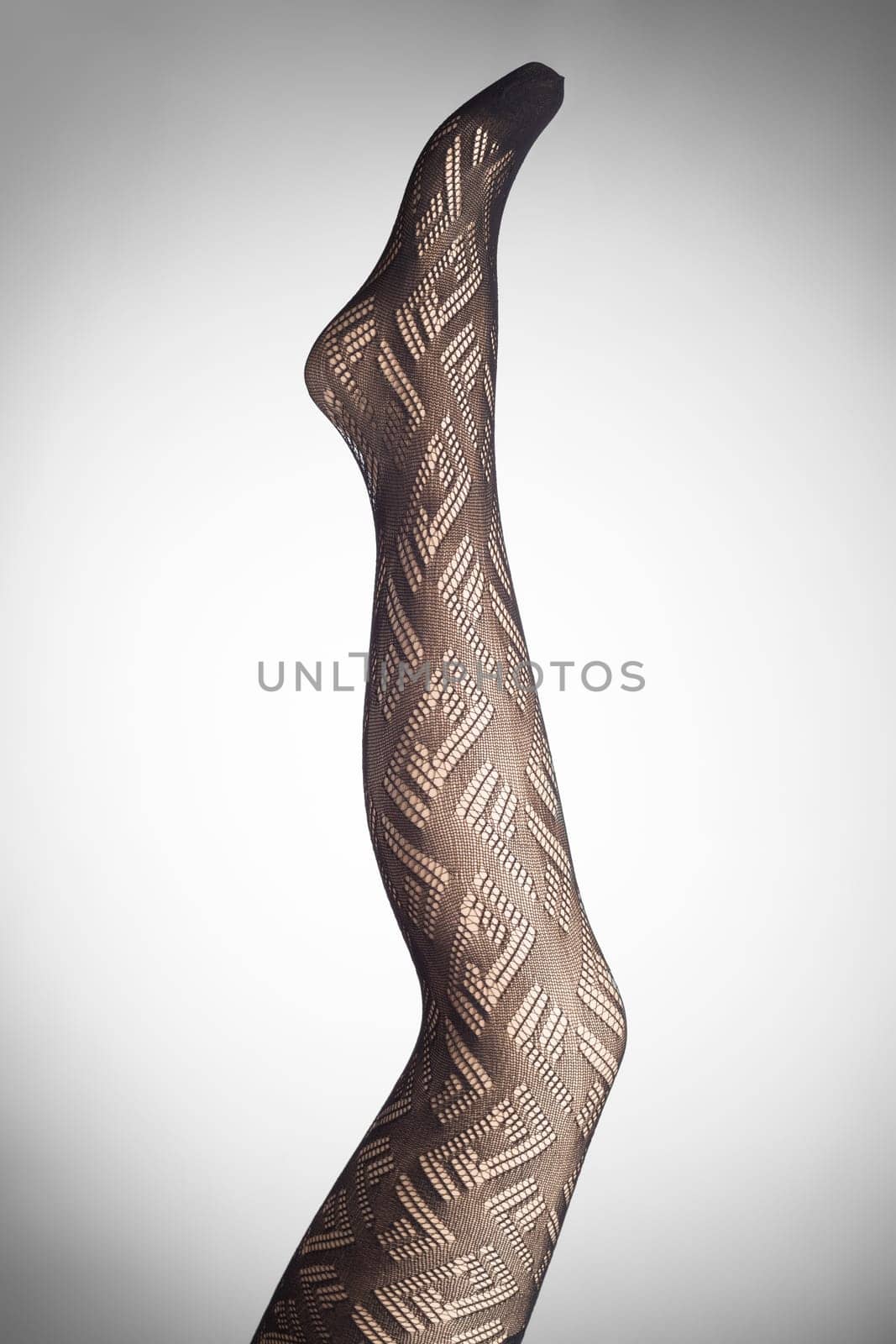 Mannequin female foot in stylish fashion pantyhose.