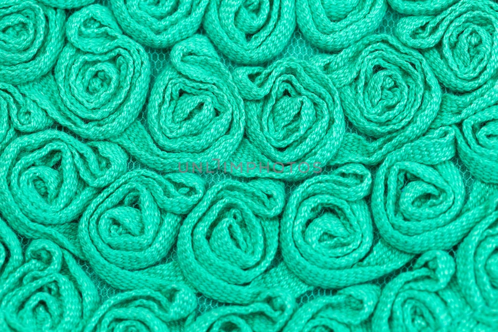 Background of green fabric in the form of bulk flowers.