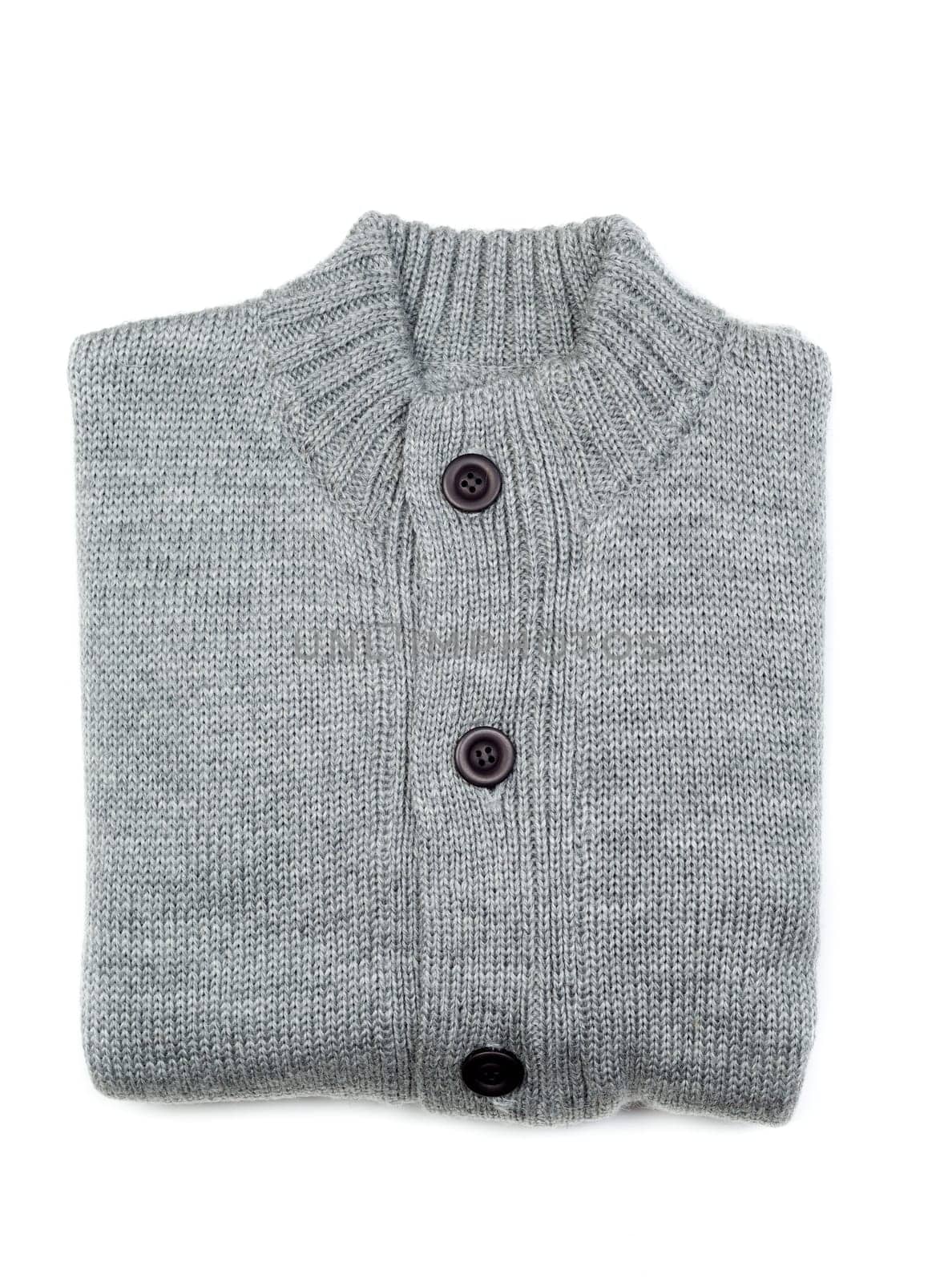 Grey knit sweaters folded on white background.