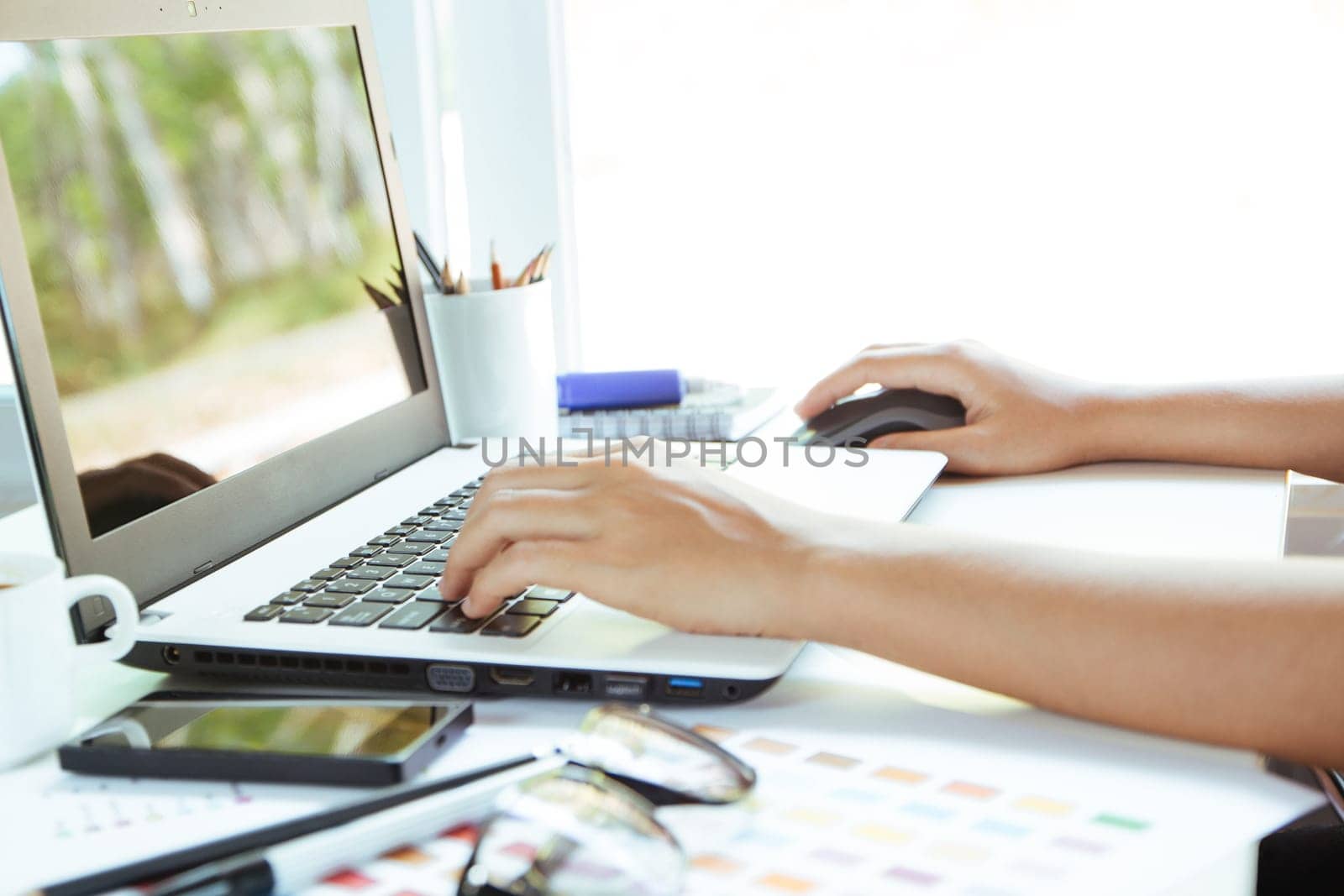 close up hand using laptop on desk