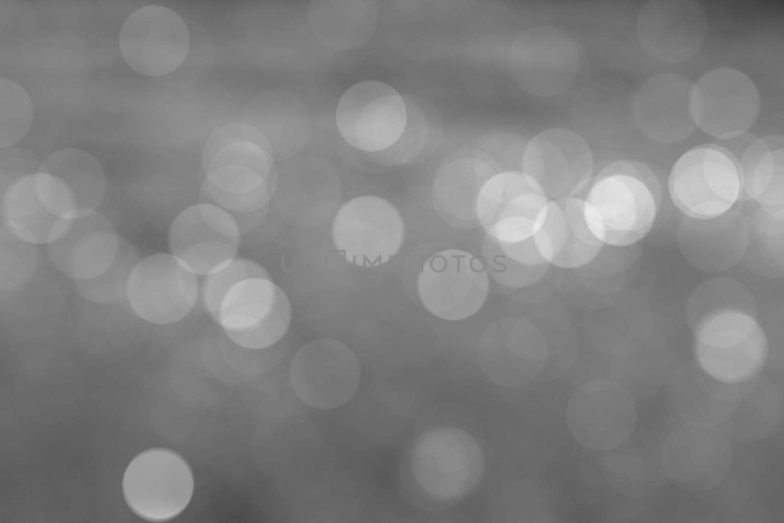 Abstract circular natural light black and white bokeh background