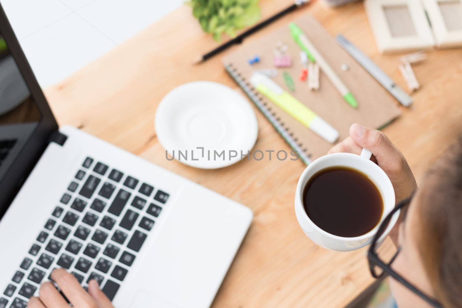 woman drink coffee and use laptop computer on desk