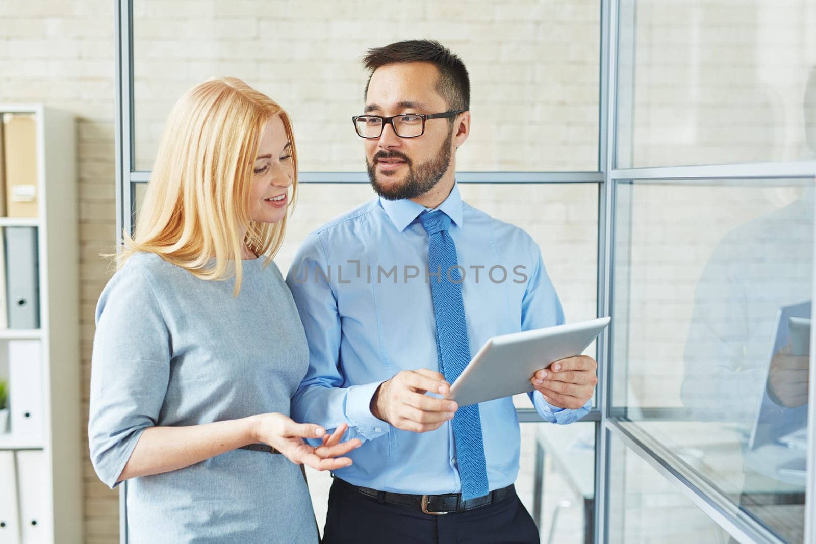 Young manager talking to female chief