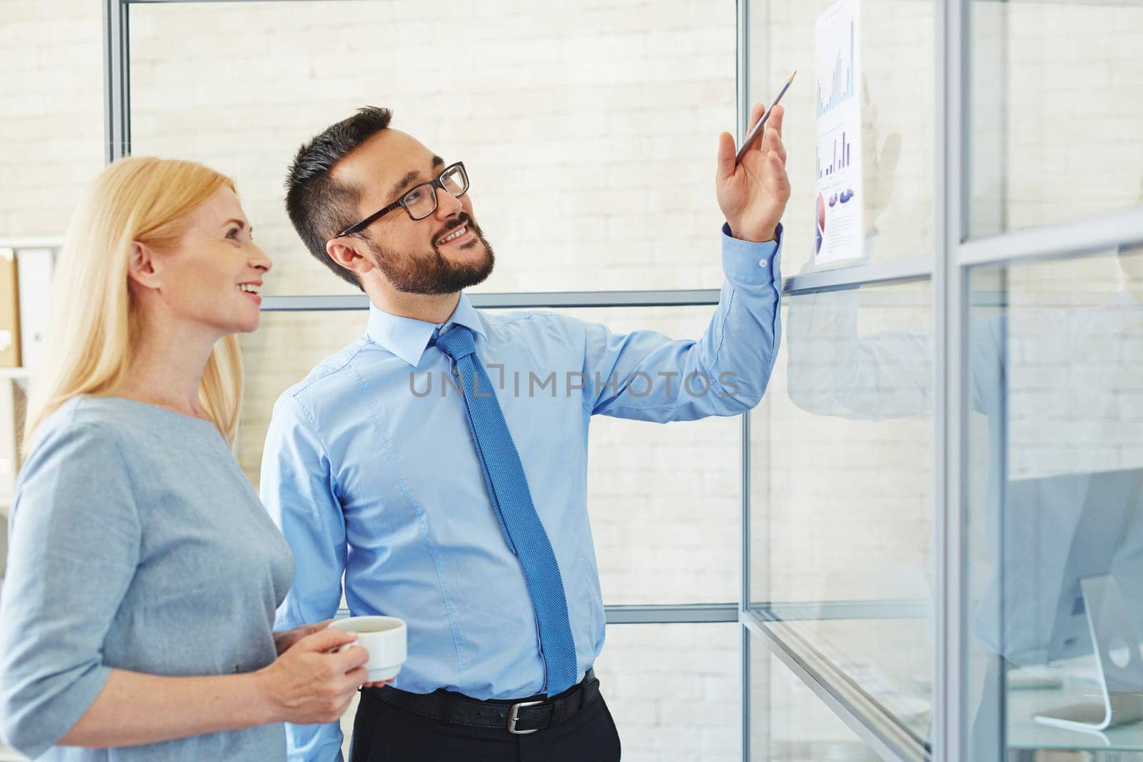 Young businessman showing his plan to CEO