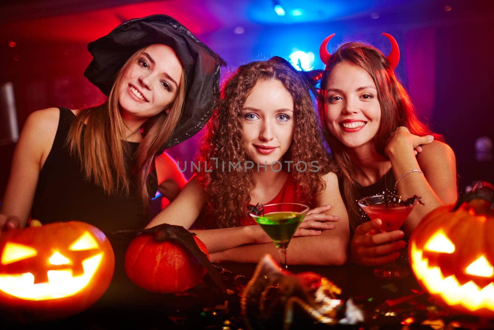 Portrait of three girlfriends at Halloween night