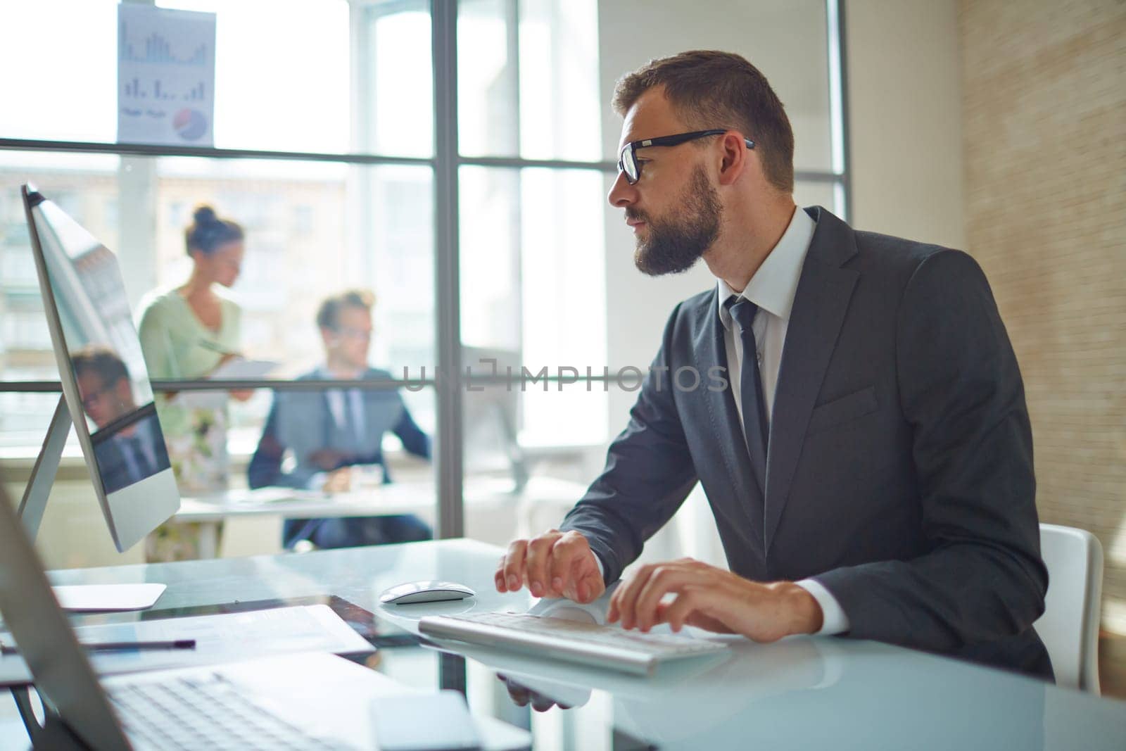Young employee looking at computer monitor