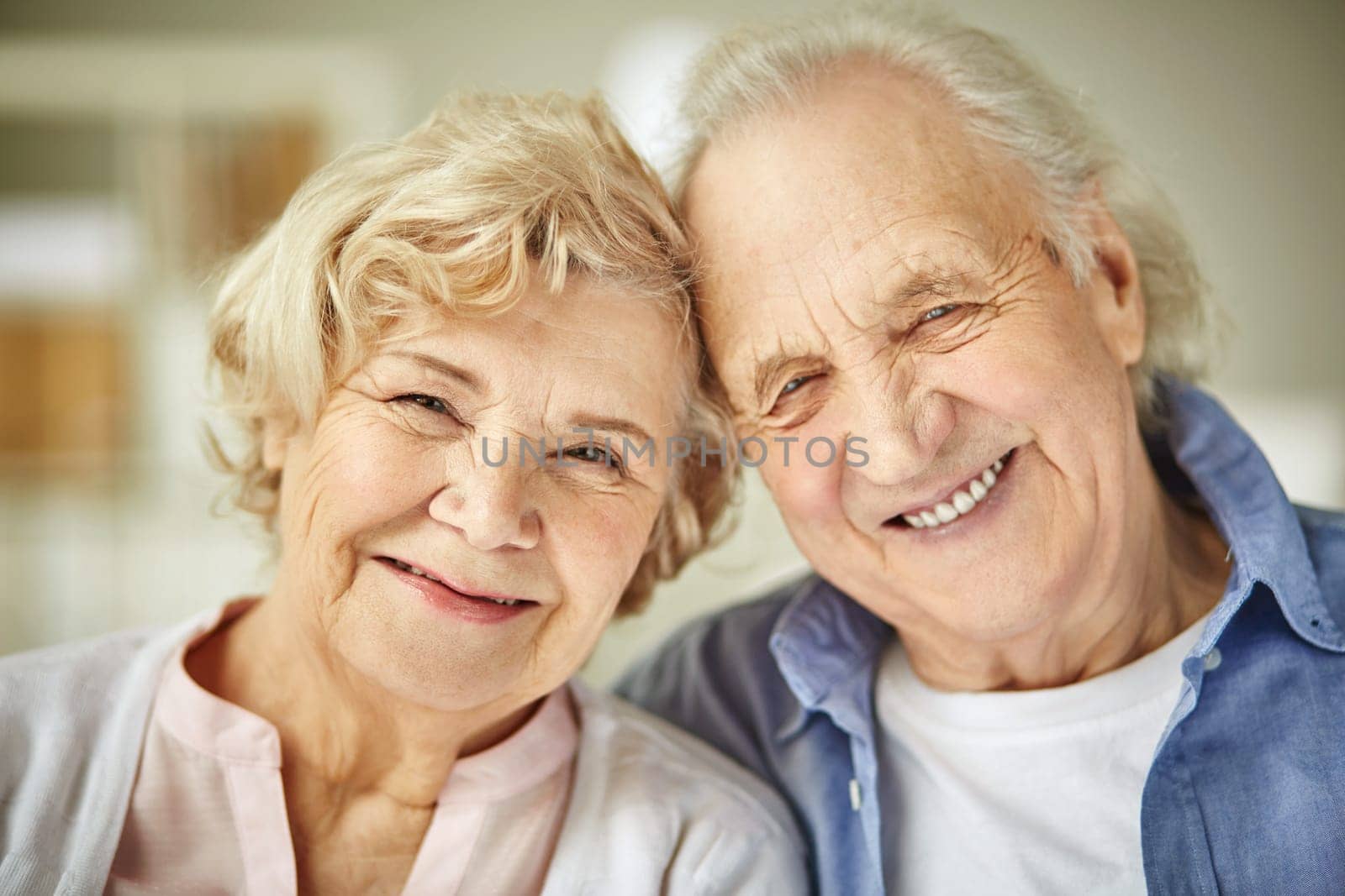 Smiley faces of affectionate senior couple