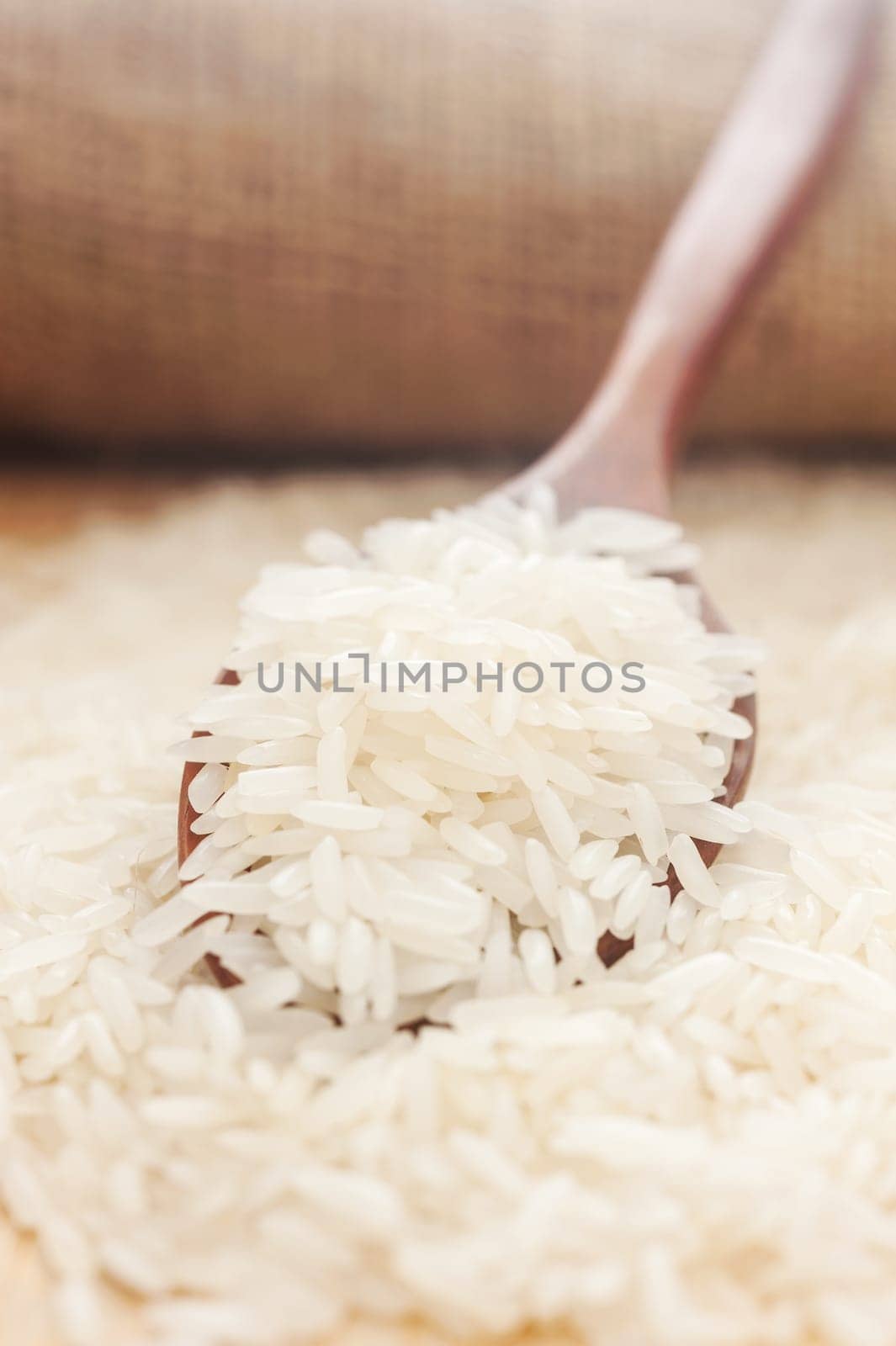 Rice, White rice in wooden spoon with hemp background, Selective focus