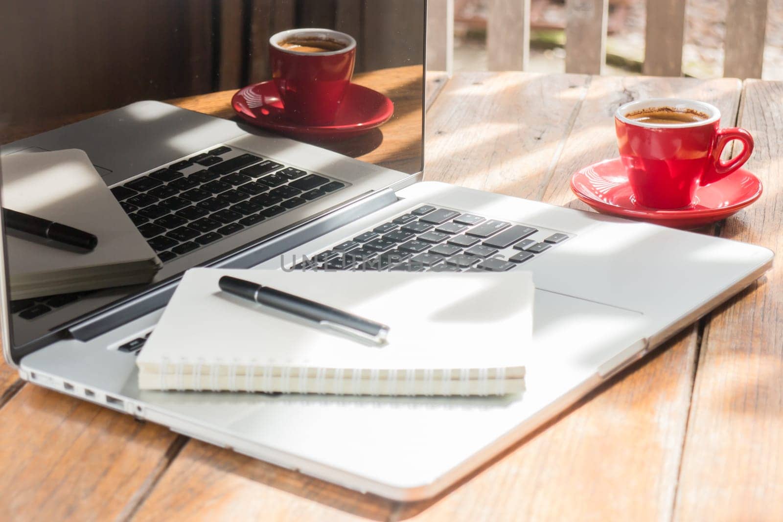 Hot coffee cup on wooden work station, stock photo
