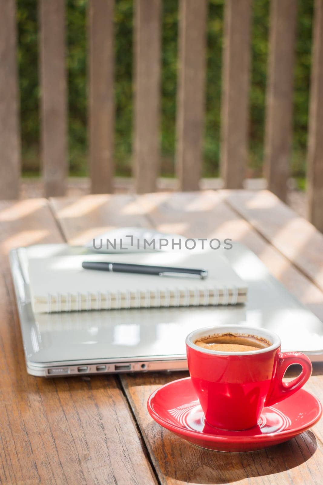 Hot coffee cup on wooden work station, stock photo
