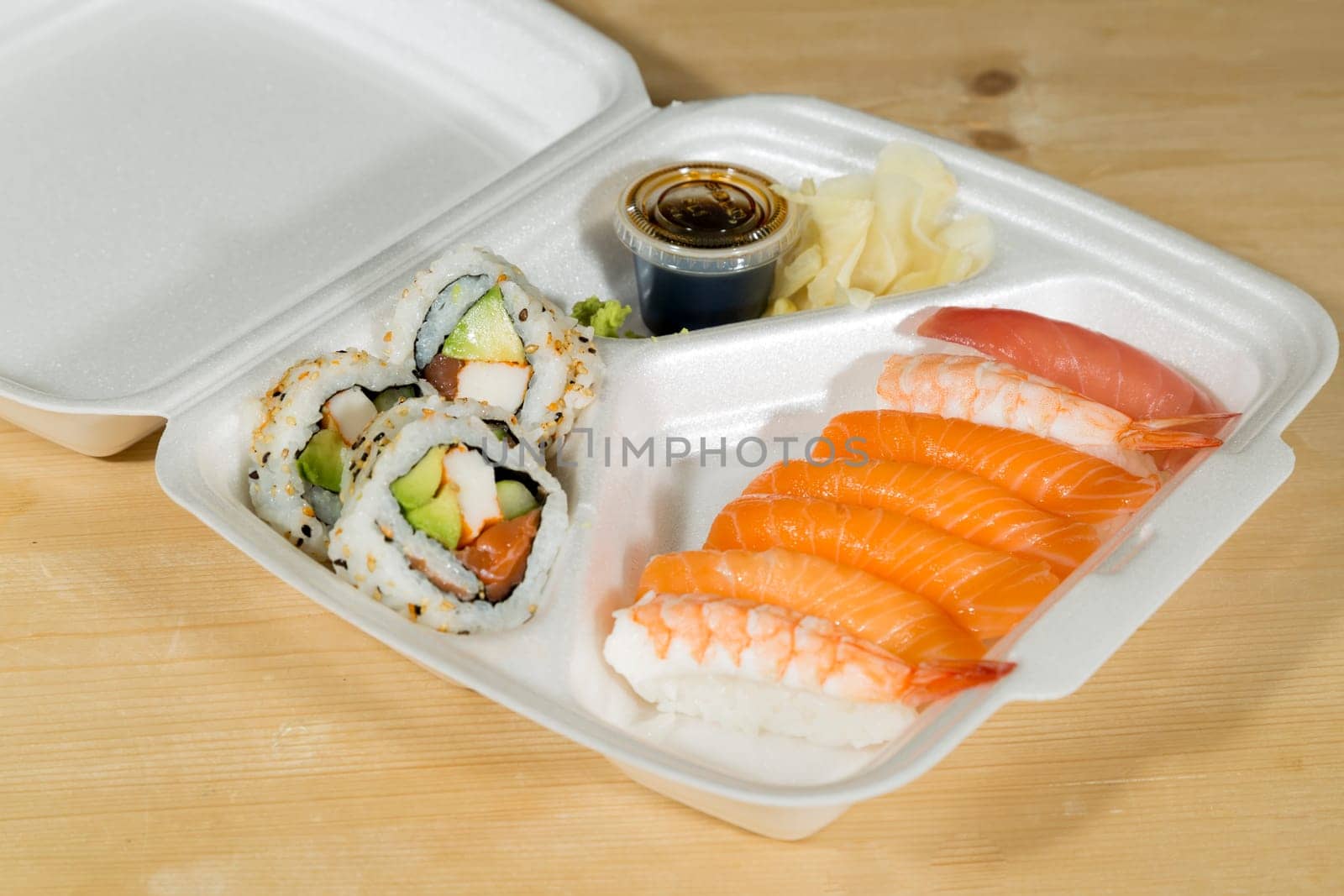 Fast Food Sushi in its box on wooden table.