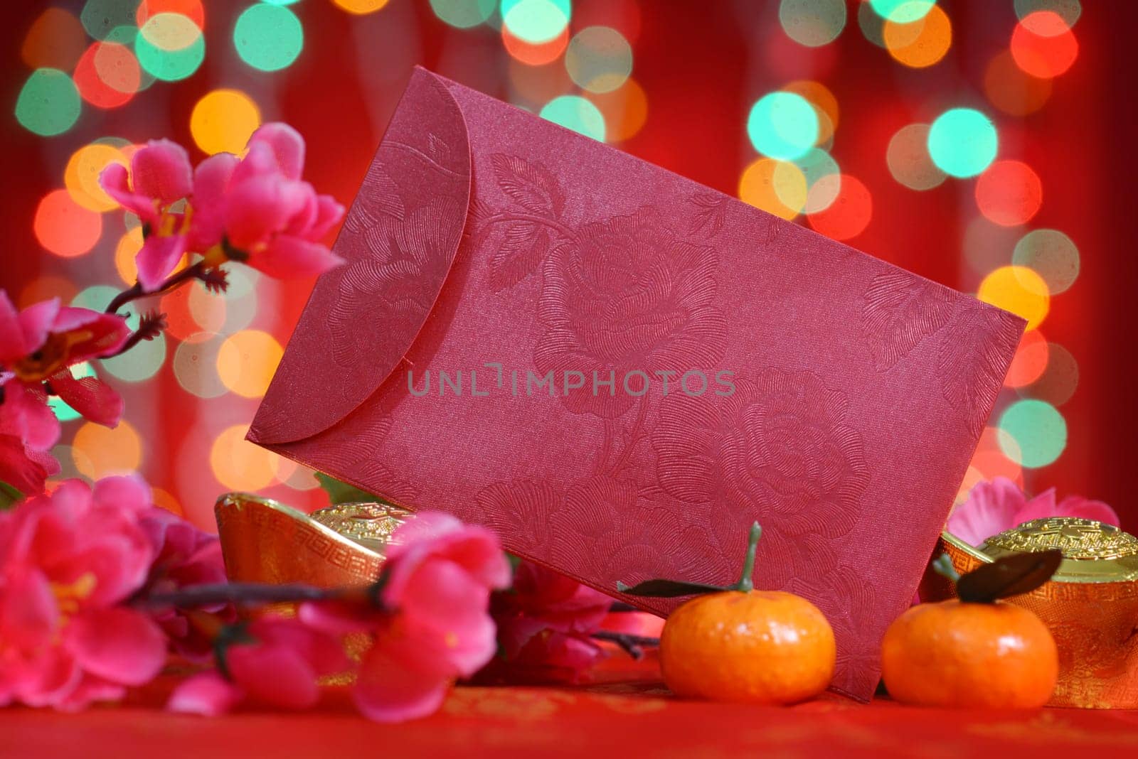 Chinese new year festival decorations, ang pow or red packet with copy space ready for text, on glitter red background.