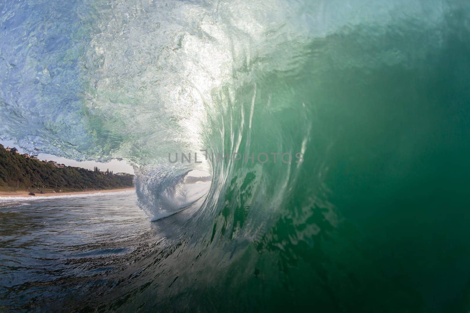 Ocean wave swimming inside crashing water power tube detail.