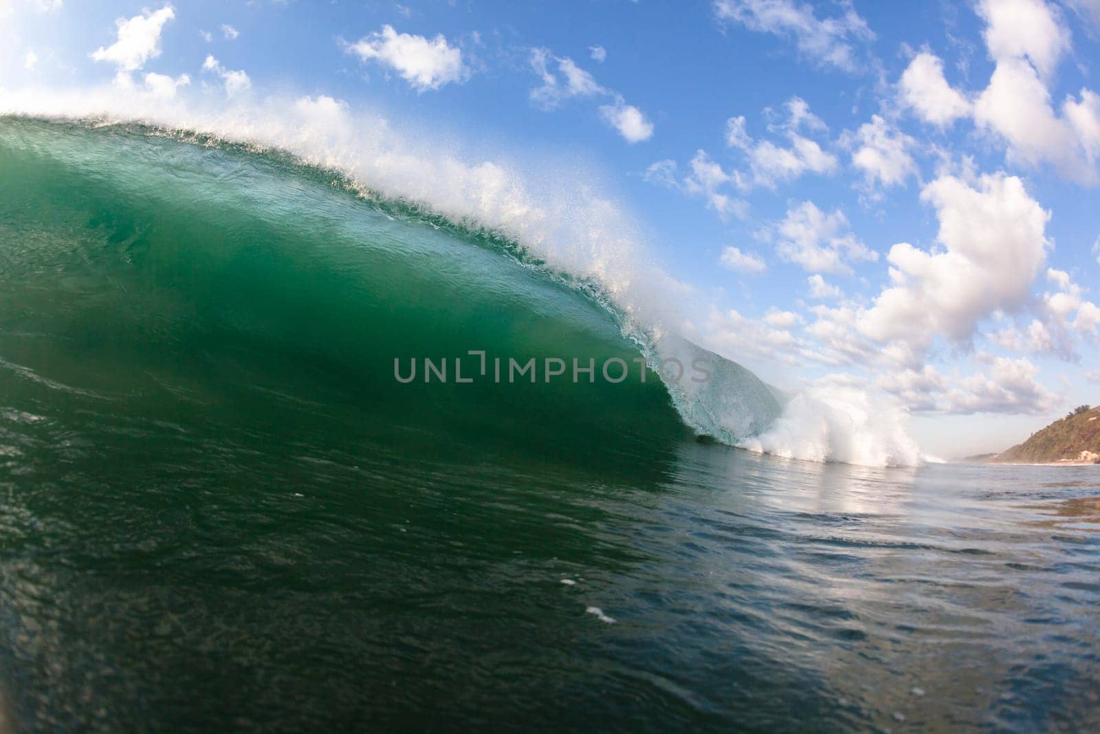 Ocean wave swimming inside crashing water power tube detail.