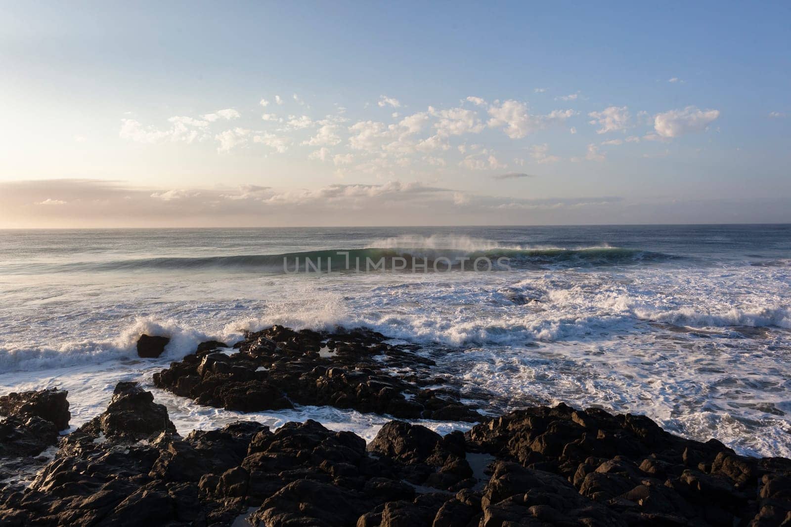 Ocean waves water crashing hollow energy power along rocky coastline.