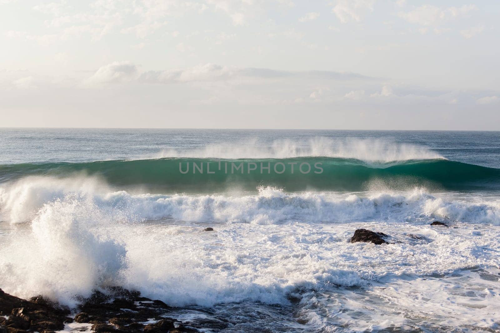 Ocean waves water crashing hollow energy power along rocky coastline.