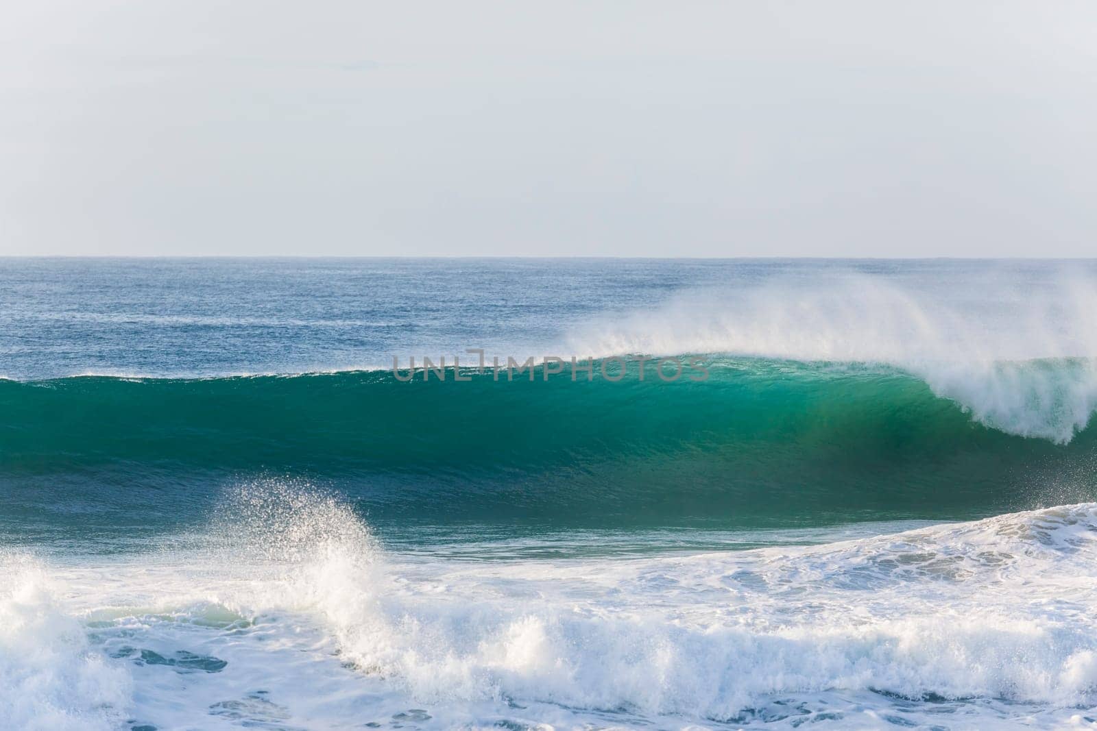 Ocean waves water crashing hollow energy power along rocky coastline.