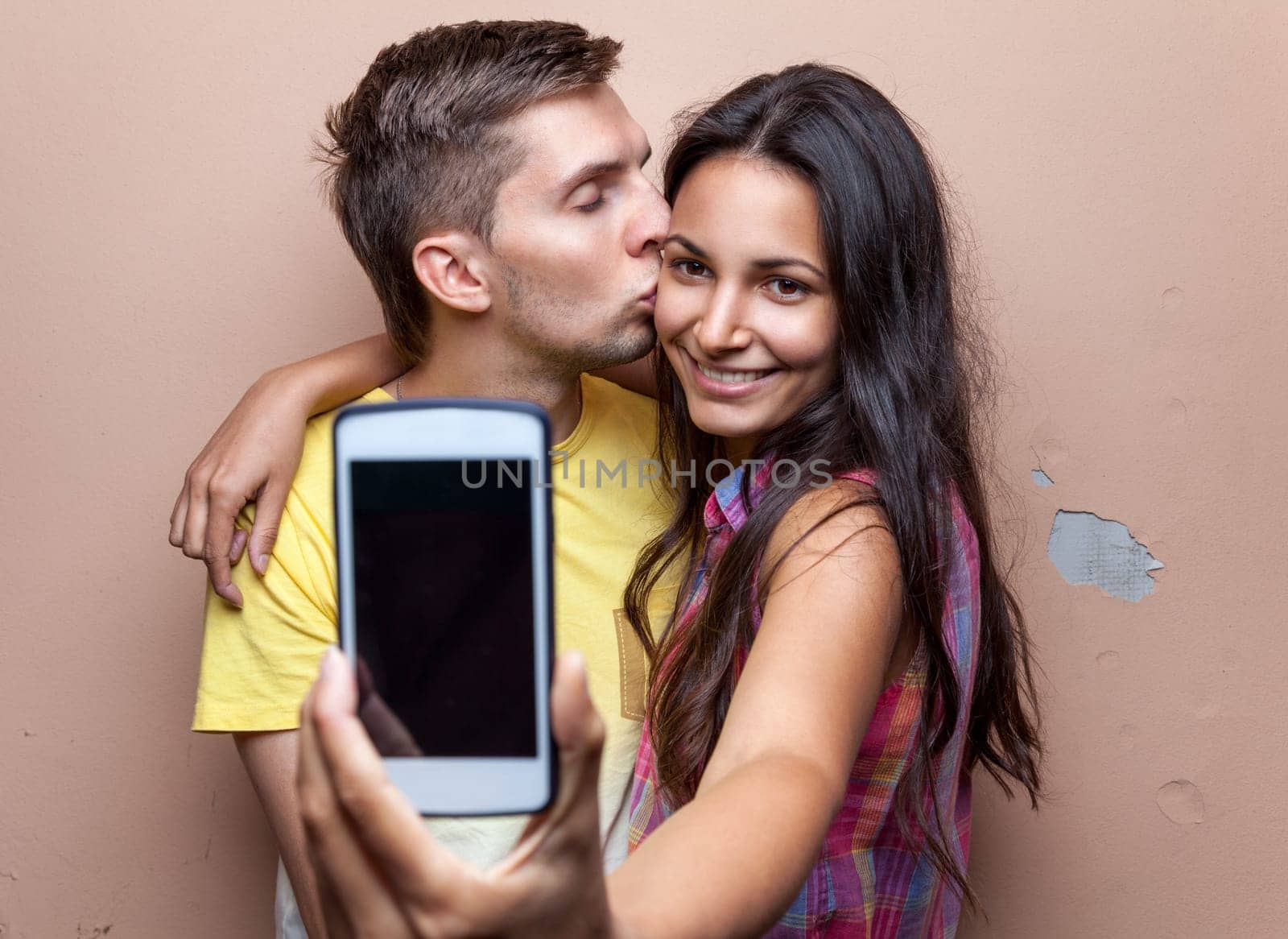 Young happy couple in love taking a selfie