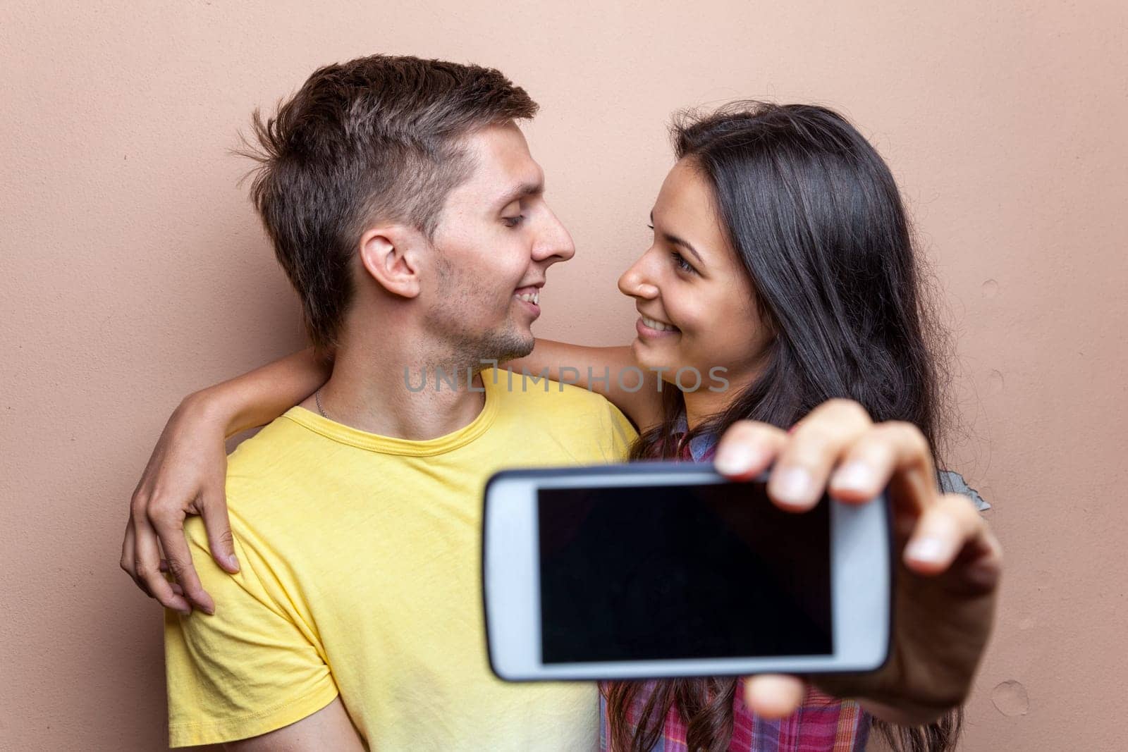 Young happy couple in love taking a selfie