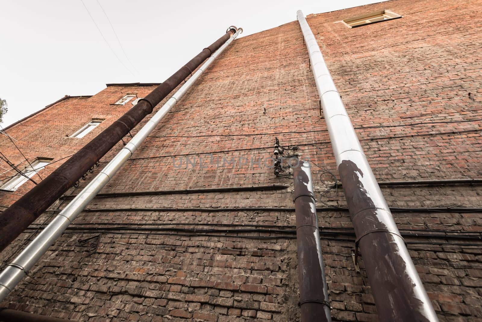 Series of pipes on a brick brown wall ukraine