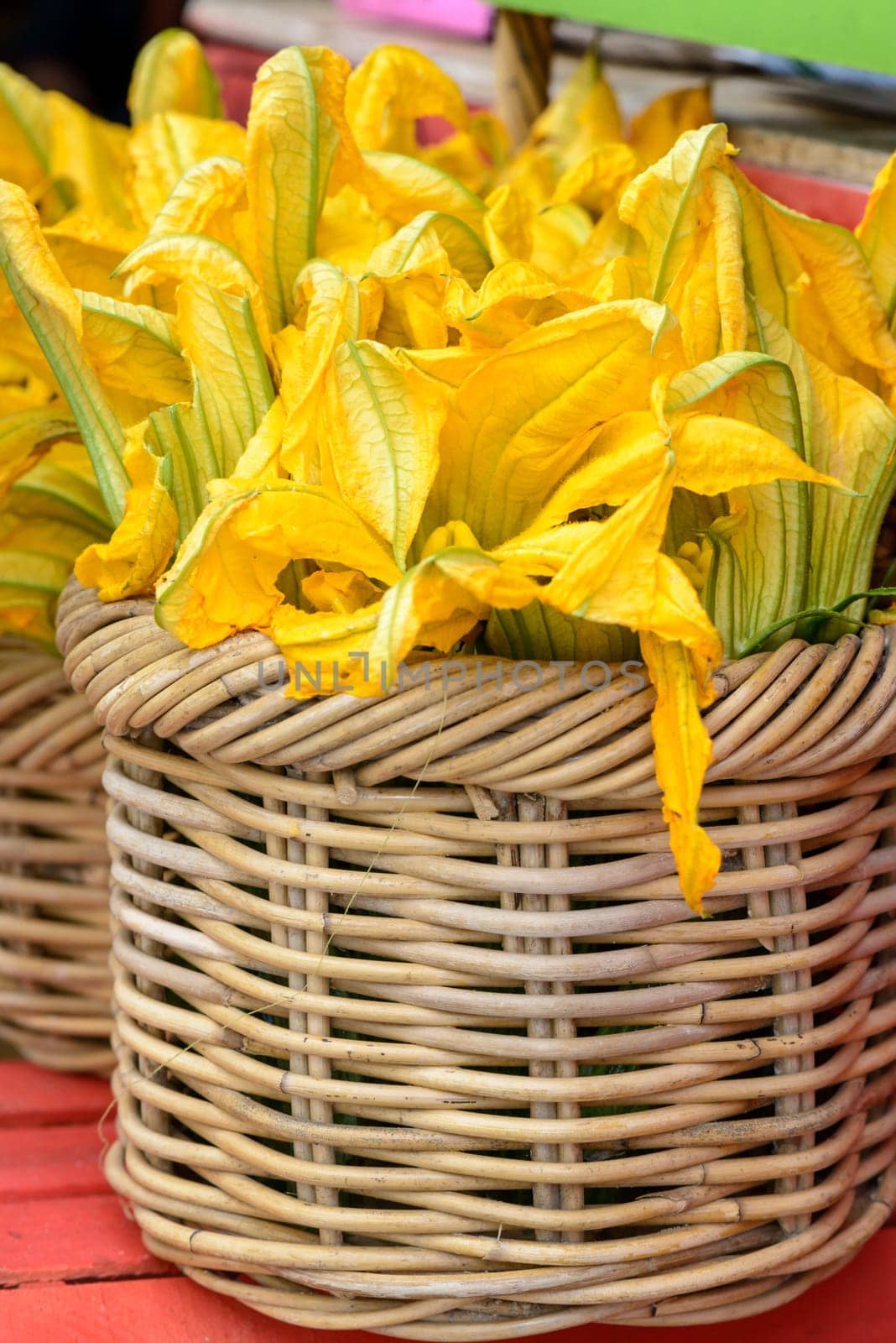 zucchini flowers in a wicker basket, typical italian food