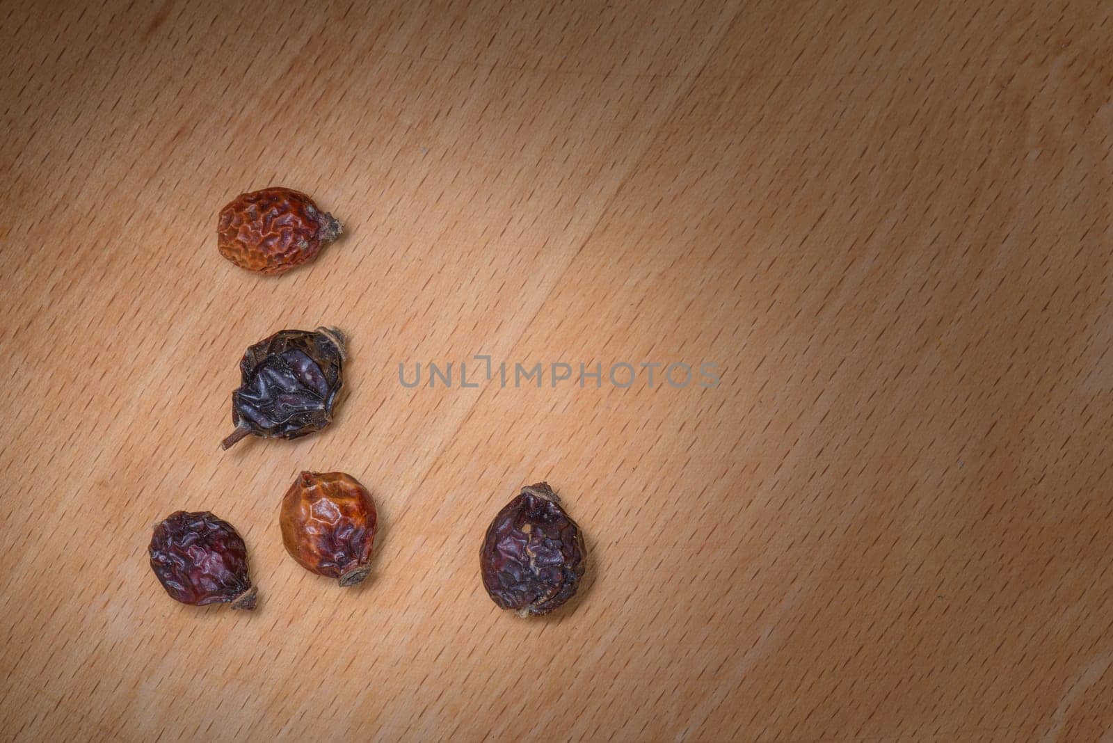 Dry Rosehip fruit for healty tisane on wood