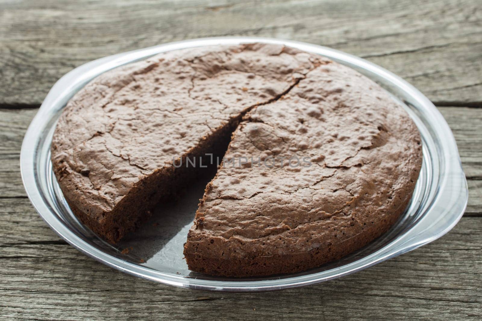 Chocolate cake in the backlight on a plate