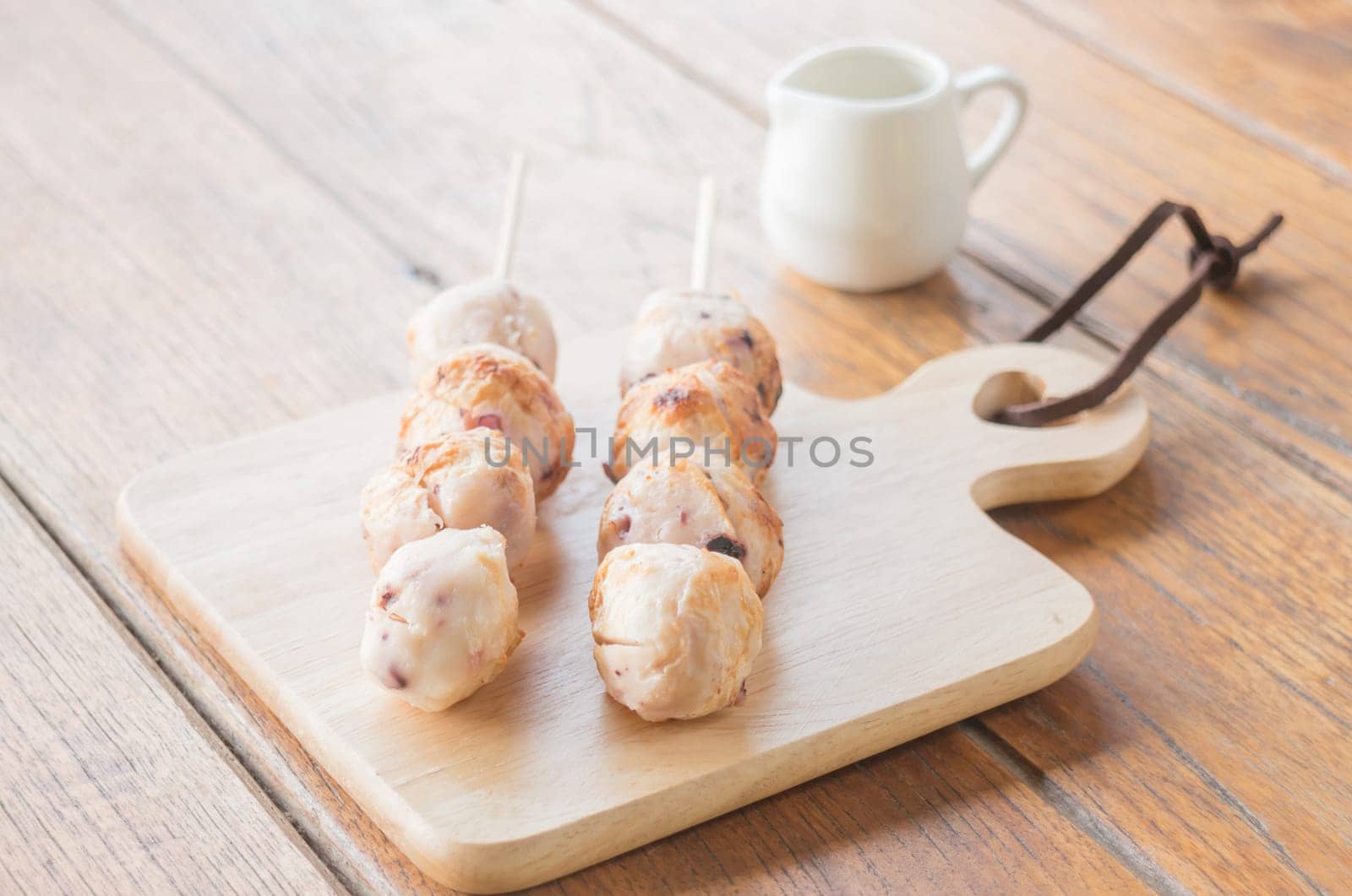 Squid grilled ball on wooden plate, stock photo