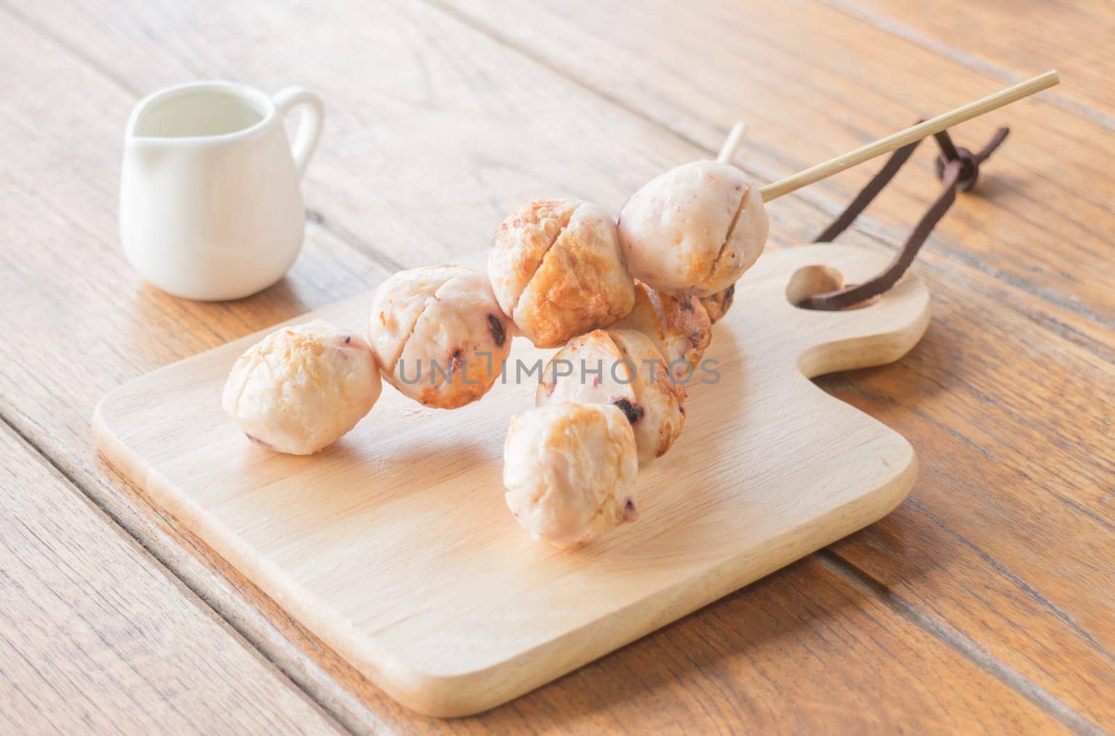 Squid grilled ball on wooden plate, stock photo