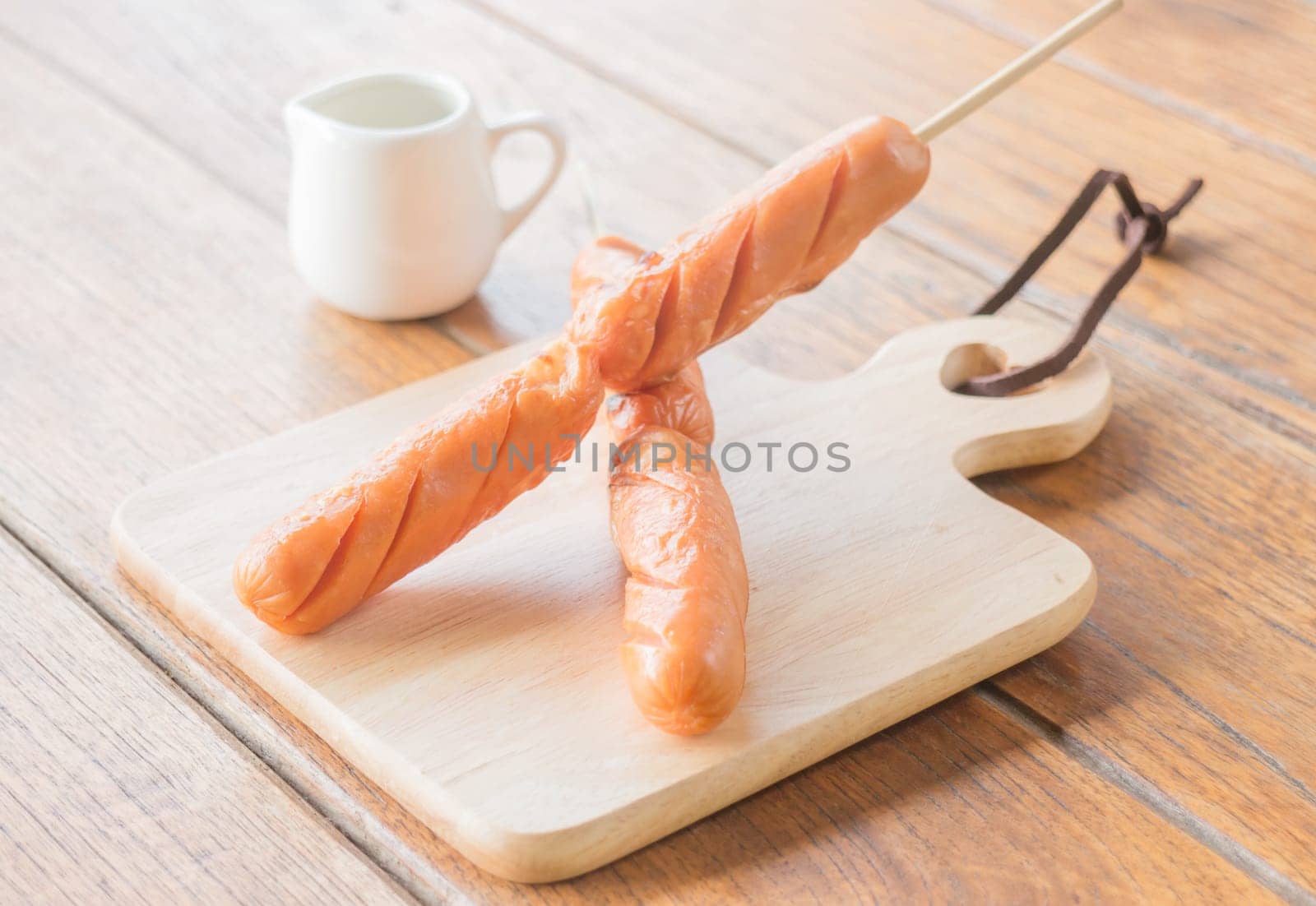 Pork hotdog grilled on wooden plate