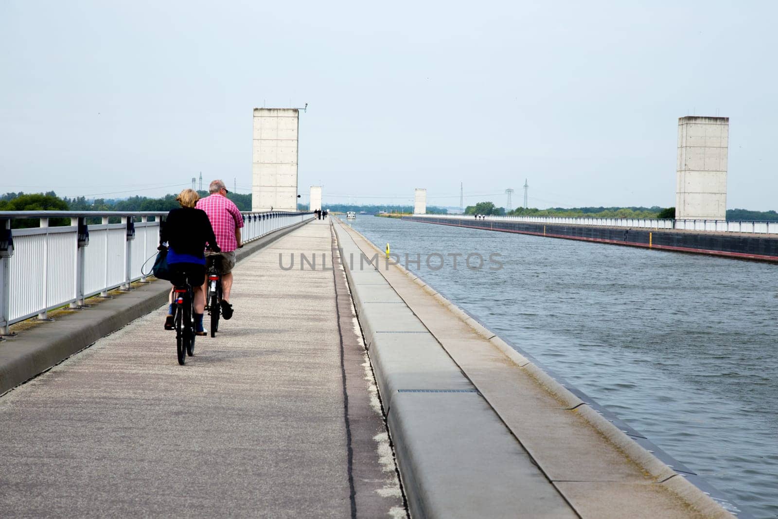 Two cyclists cross the bridge of the Elbe-Havel Canal over the Elbe