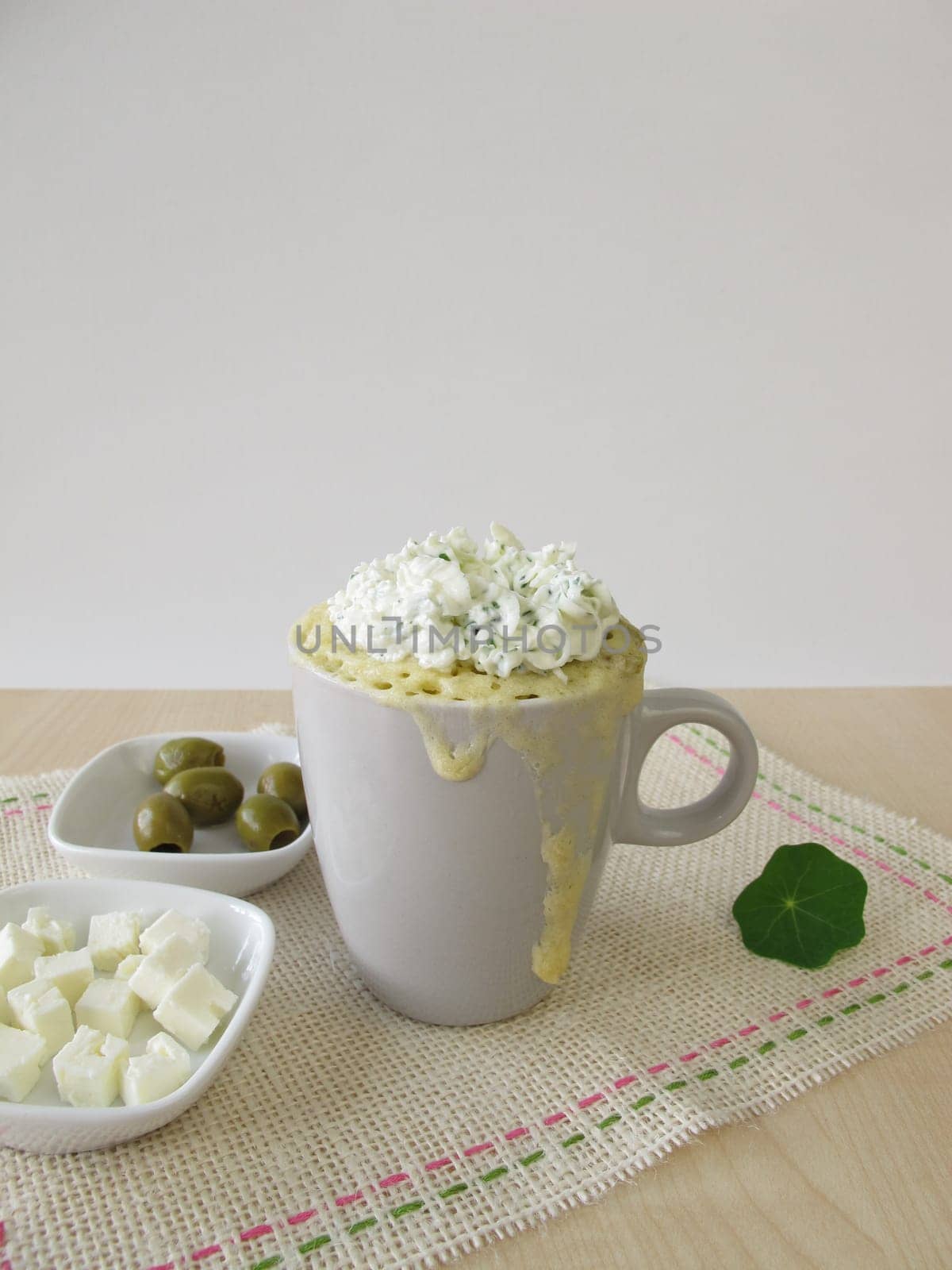 Mug Cake with olives,feta cheese and herbal quark topping