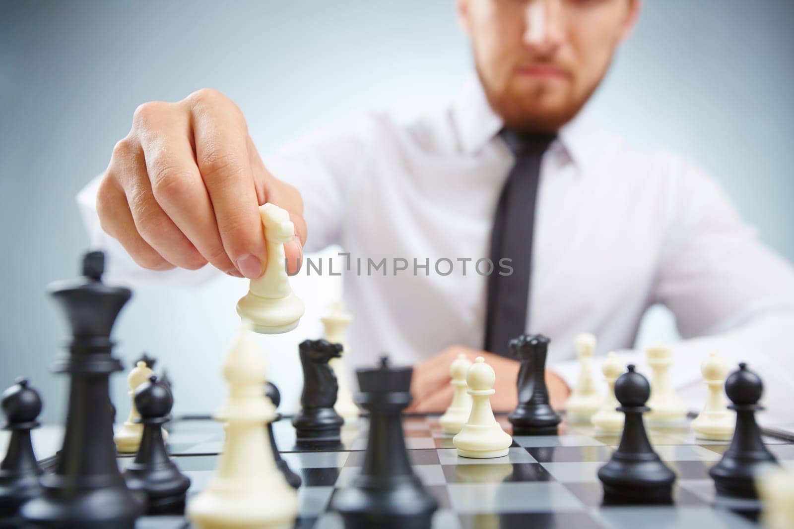 Businessman with knight checkmating his rival