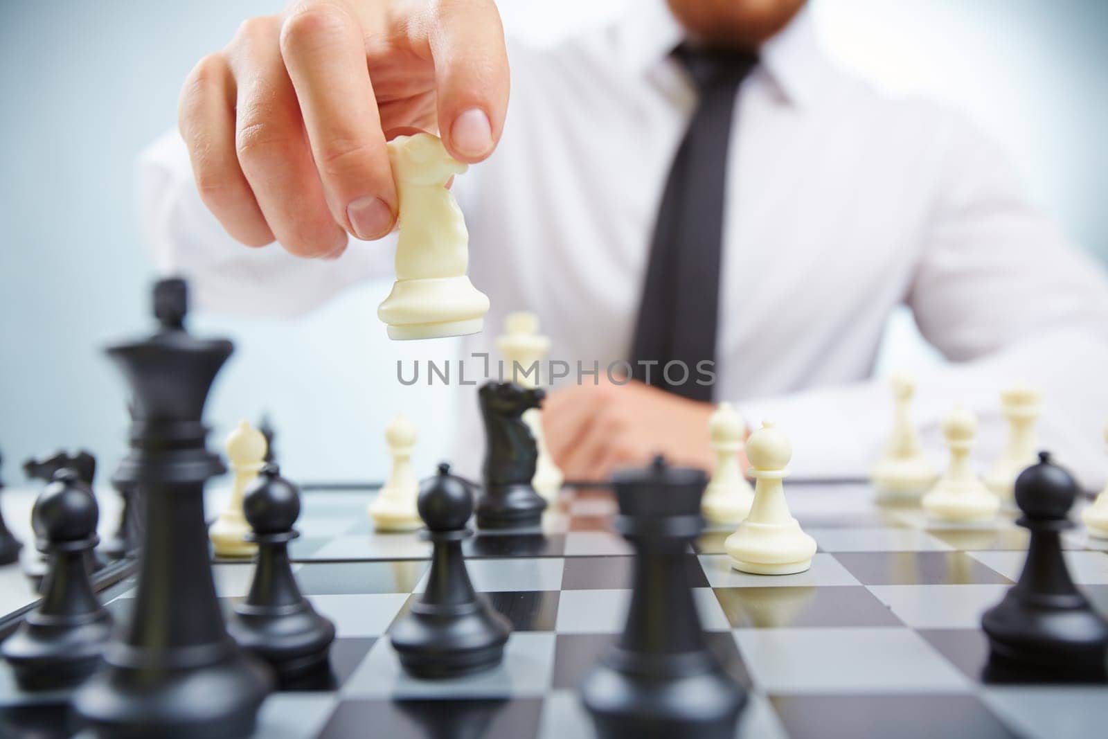 Businessman with knight playing chess