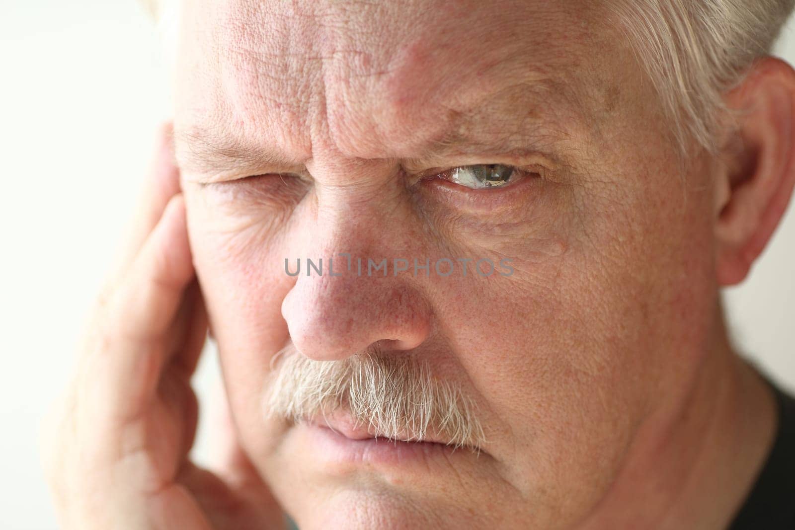 unhappy older man with facial soreness
