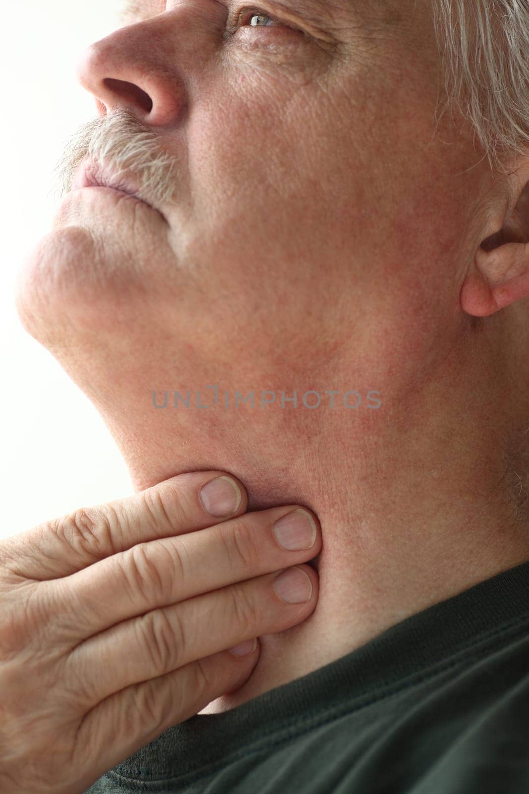 Older man has a problem with swallowing or a sore throat
