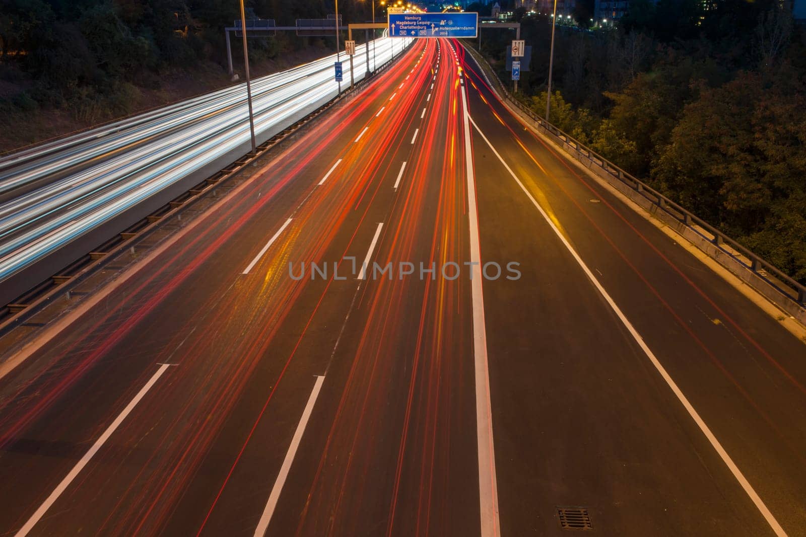 nocturnal view of the Berlin city highway with illuminated strips at night towards the city centre and radio tower